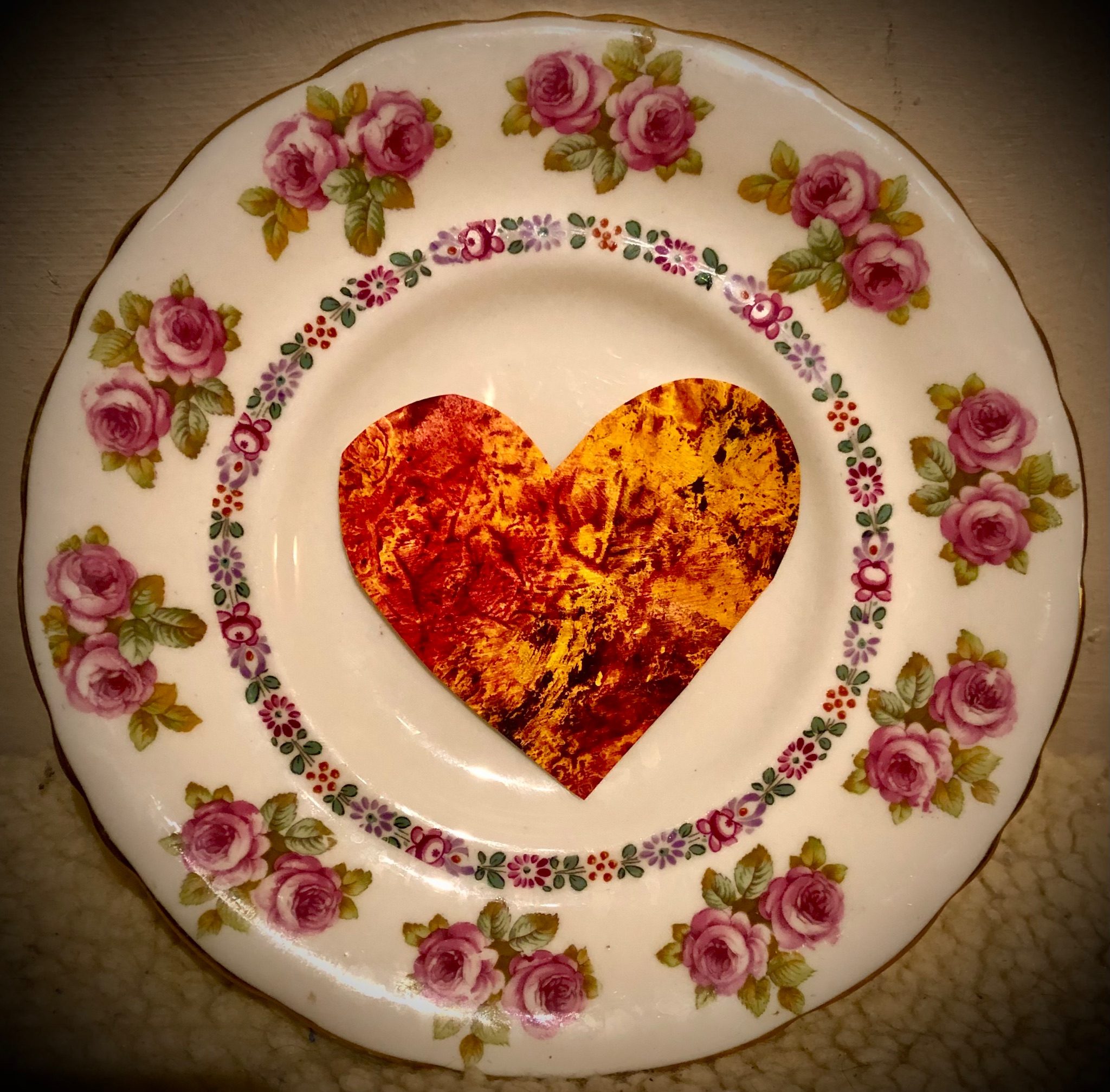 A photo of heart-shaped plasma furnace (oil on paper, by M) arranged in vintage crockery by R