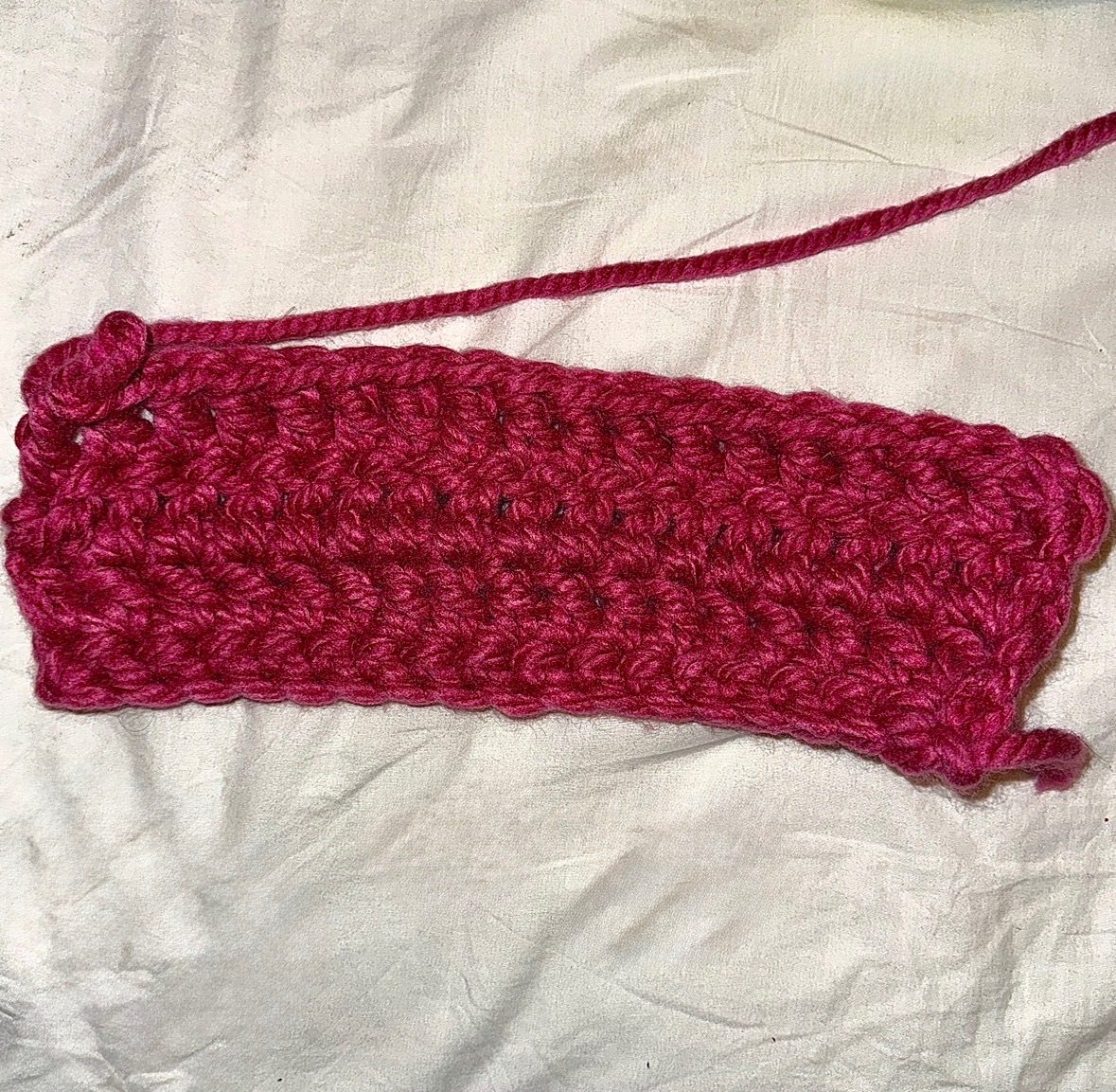 photo of the beginning of a crude crochet project made with super chunky burgundy-ish yarn