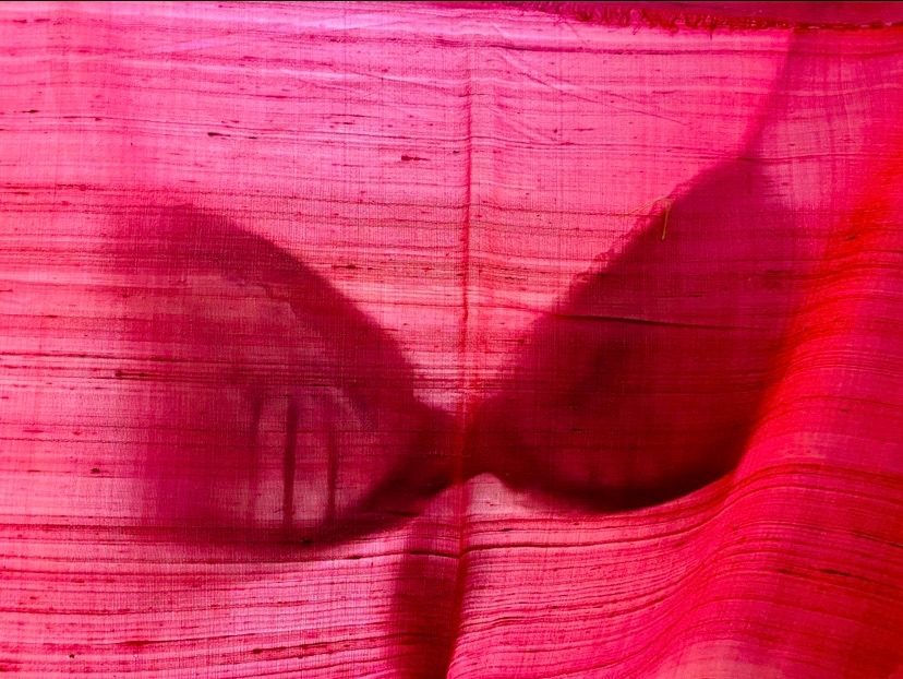 Bra silhouette on pink silk