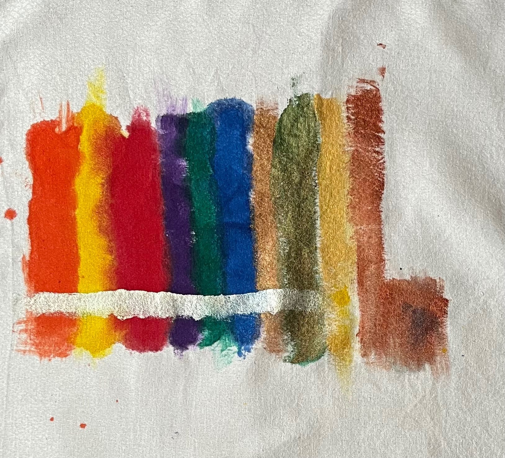 coloured ink stripes on a disused napkin, some of them metallic.