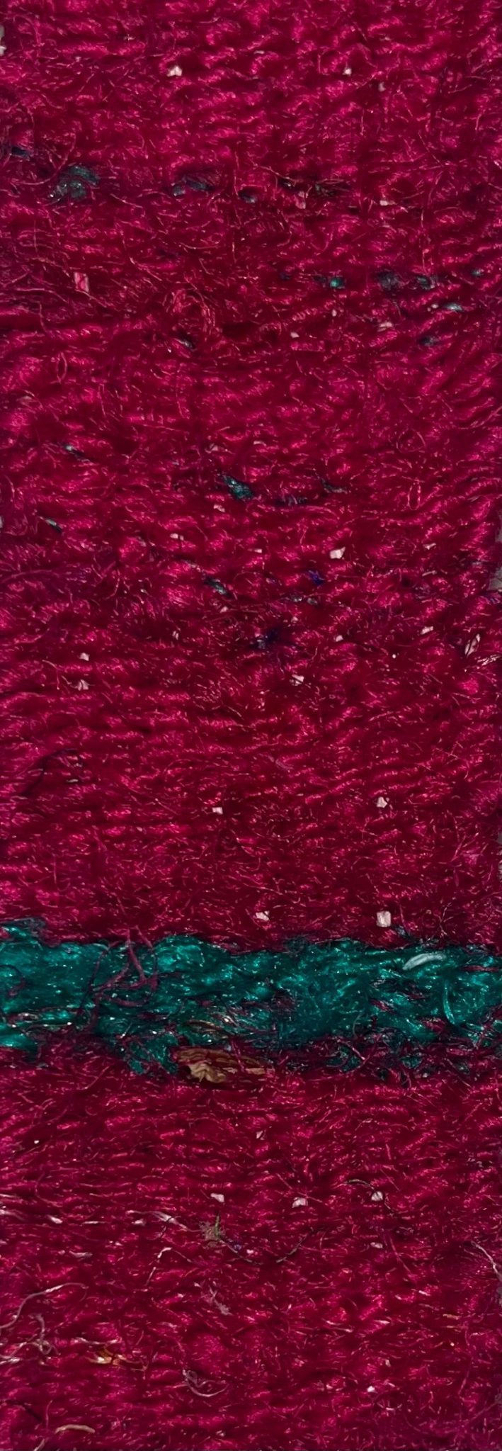 small, narrow tapestry in recycled silk waste, bright dark pink with a green strip