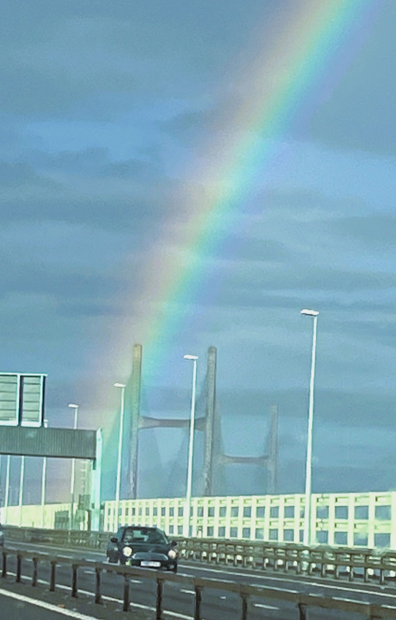 Photo of car and rainbow over Severn Bridge