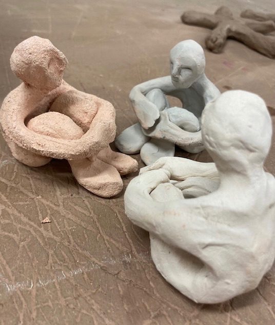 3 clay people discussing how to fix things