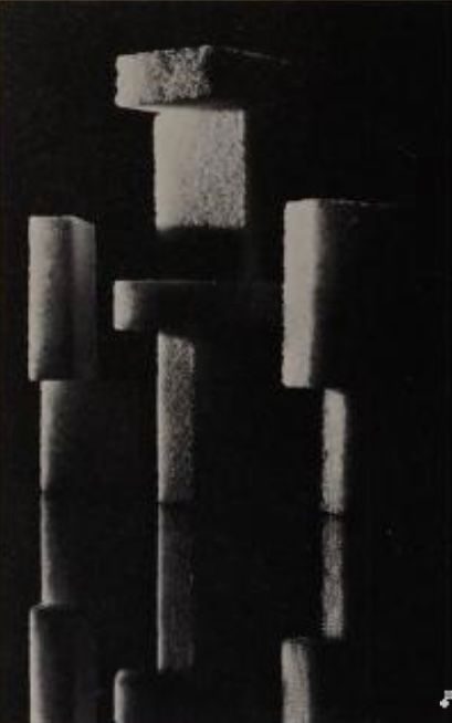 ephemeral sculpture made out of small sponge slabs precarious geometrical stackj