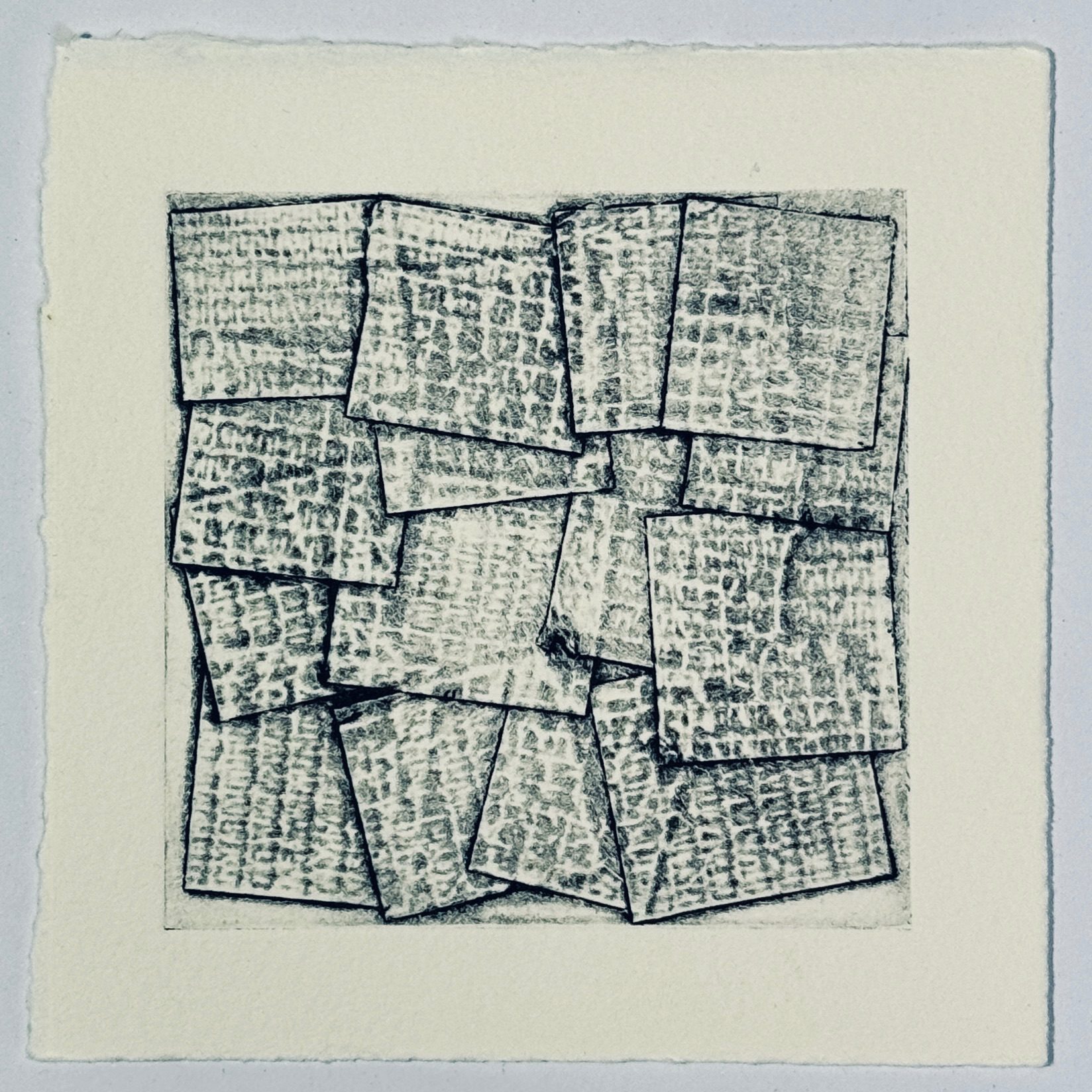 A square collagraph print on square paper. The print consists of textured overlapping squares of tape inked in black.