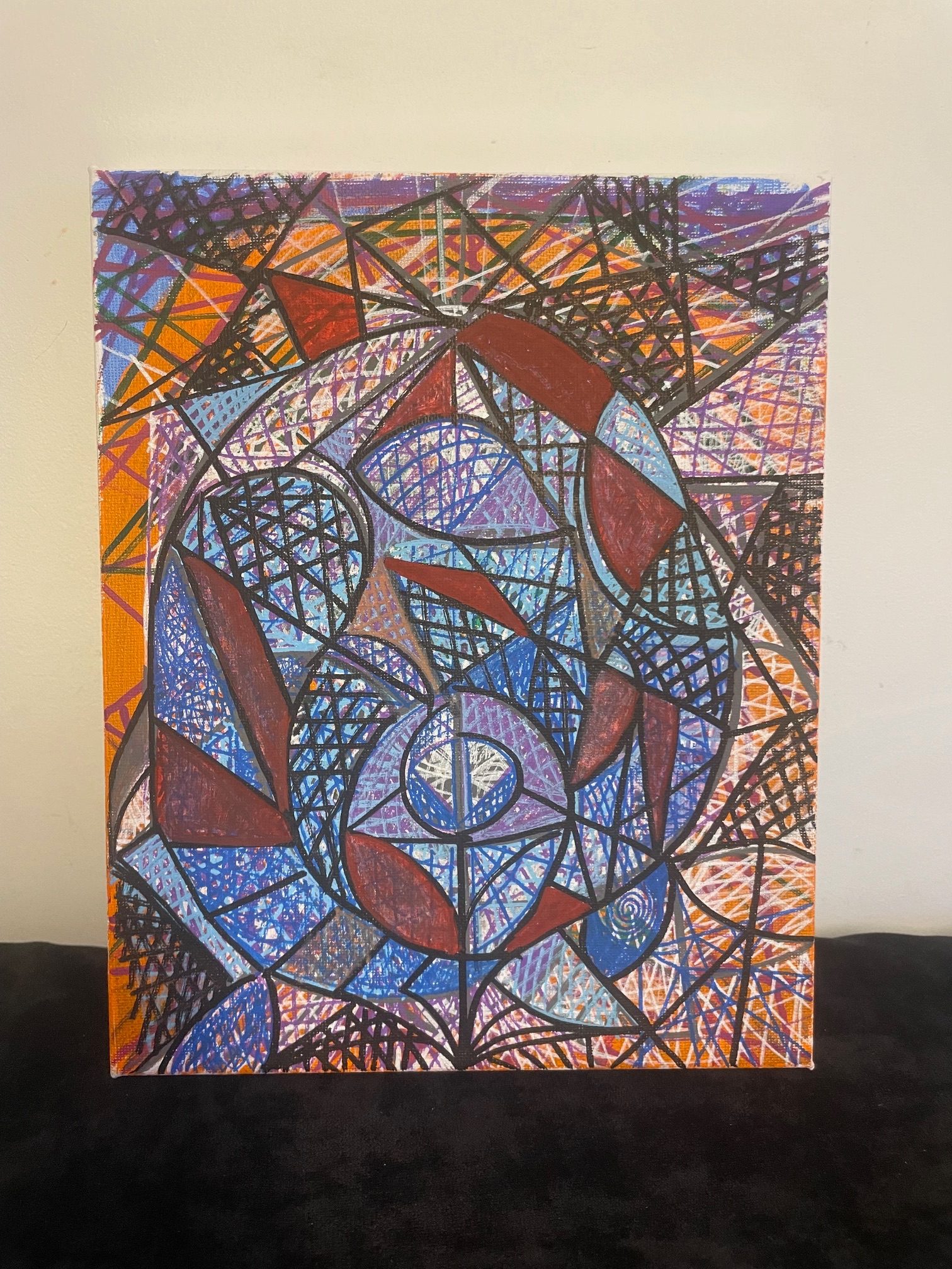 Abstract geometric form resembling a blue flower on an orange background