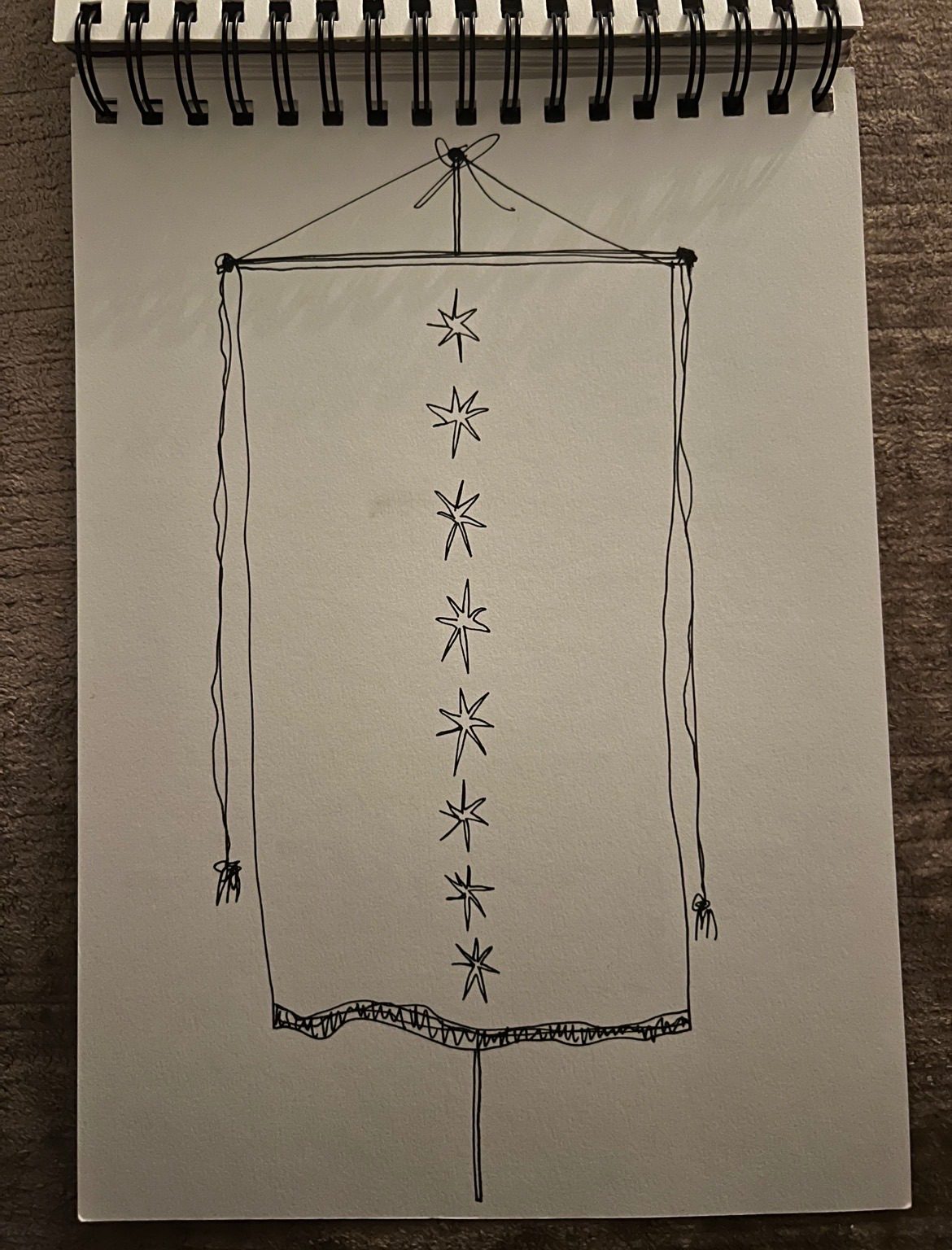 An ink drawing of a vertical banner with 8 seven pointed stars in a line