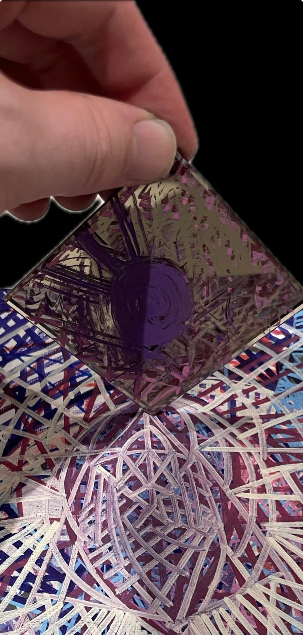 Abstract painting with mirror above it, reflecting the artwork yet also containing lines drawn on its surface