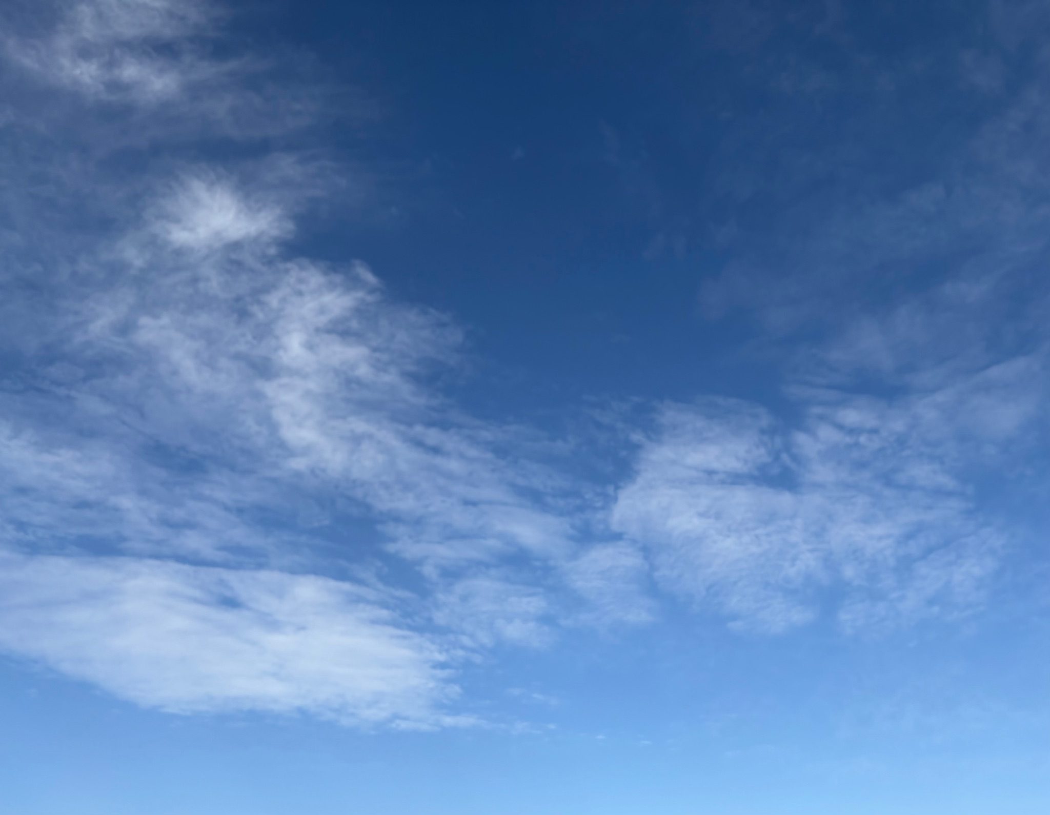 Blue sky with few clouds scattered around