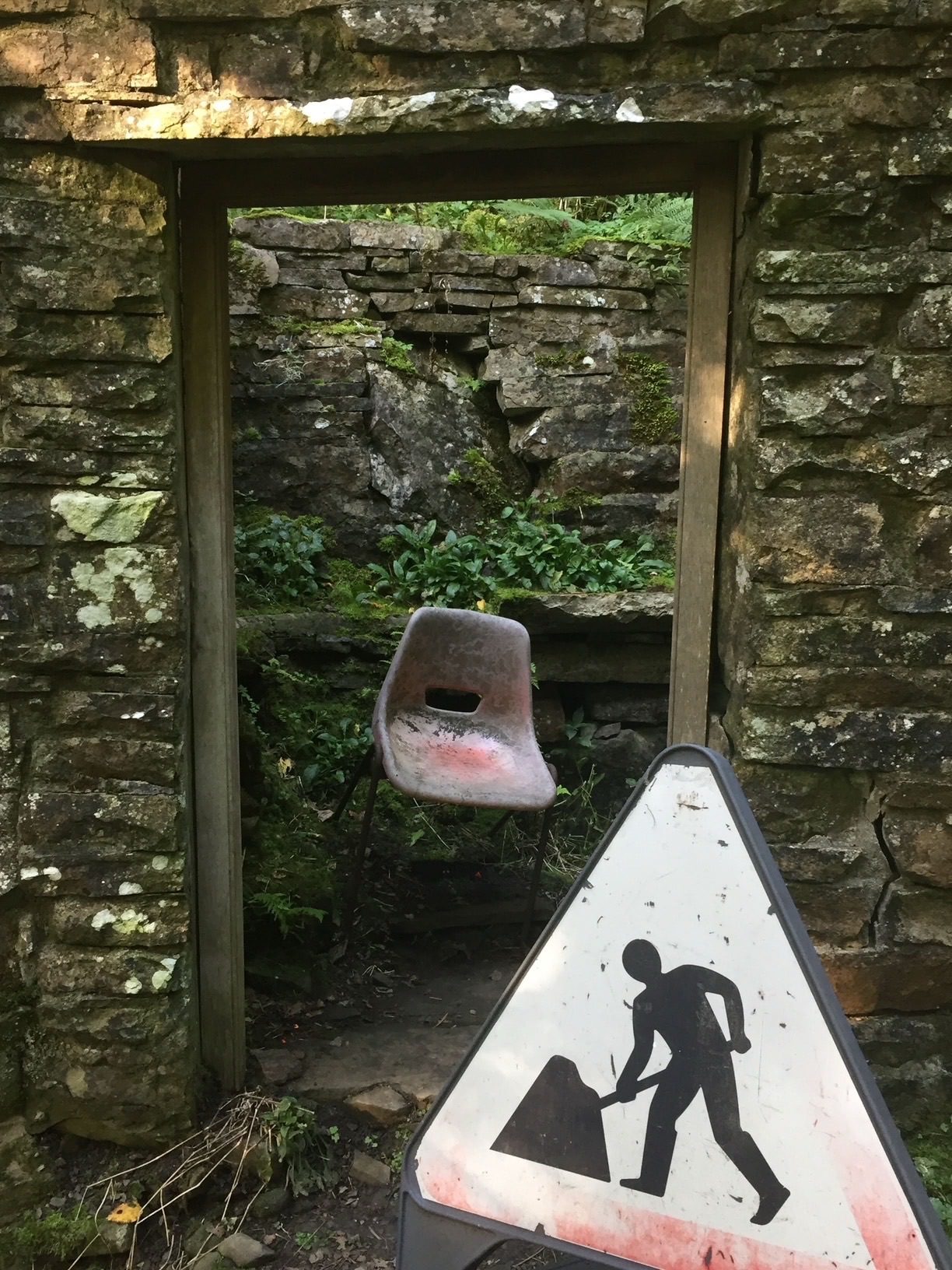 A photograph of a doorway in a ruined stone building with a discarded plastic seated chsir through the opening and a roadwork sign in front. This was arrived at by search in photos, based on page 37 of s book about the Duritti Column. The search “reification “ from a poster /sticker from Factory Records a factory sampler, threw up a random collection of 181 ,