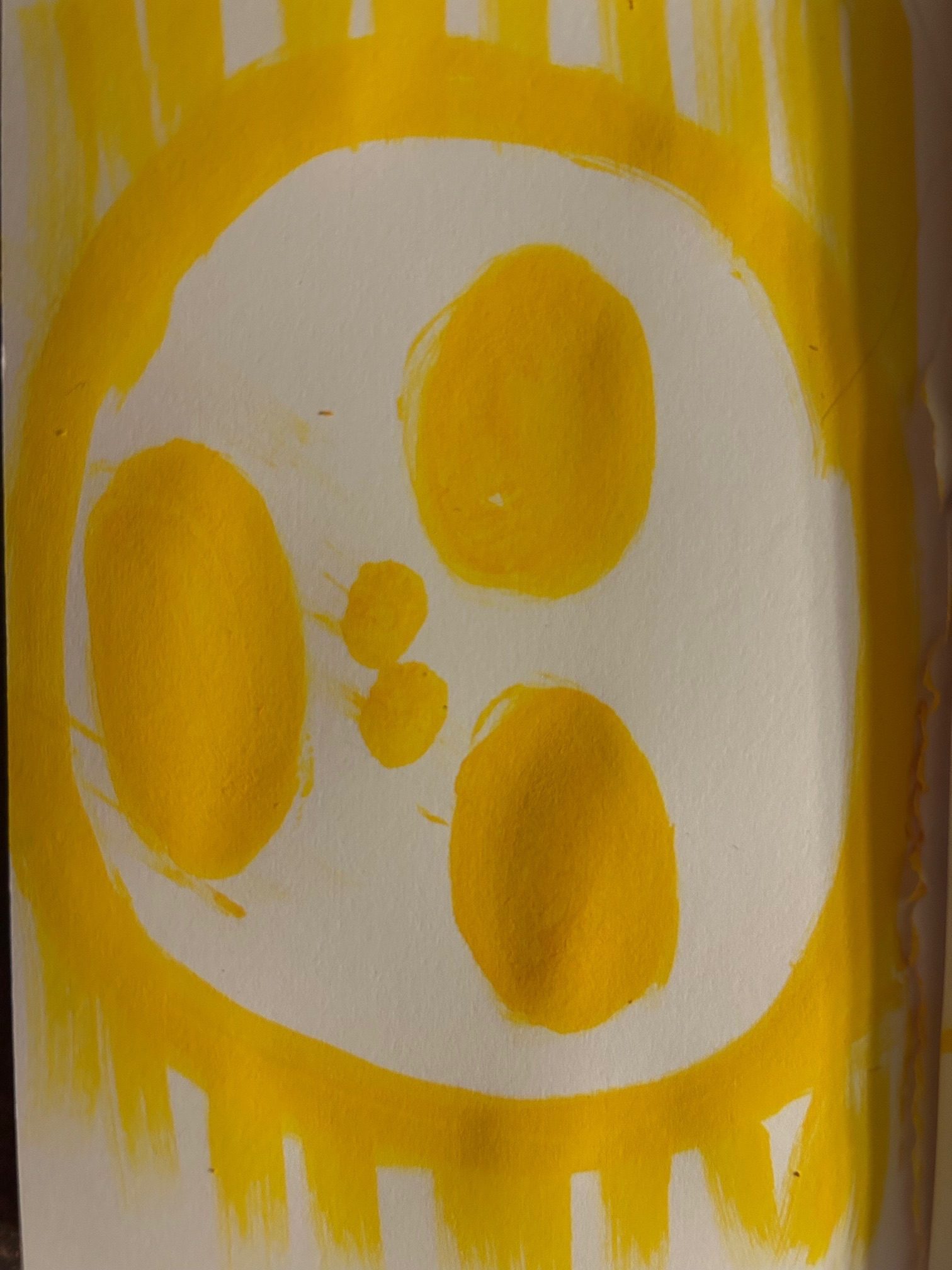 A collection of yellow solid ellipses on white within a yellow circle arranged to suggest a cartoonish gace