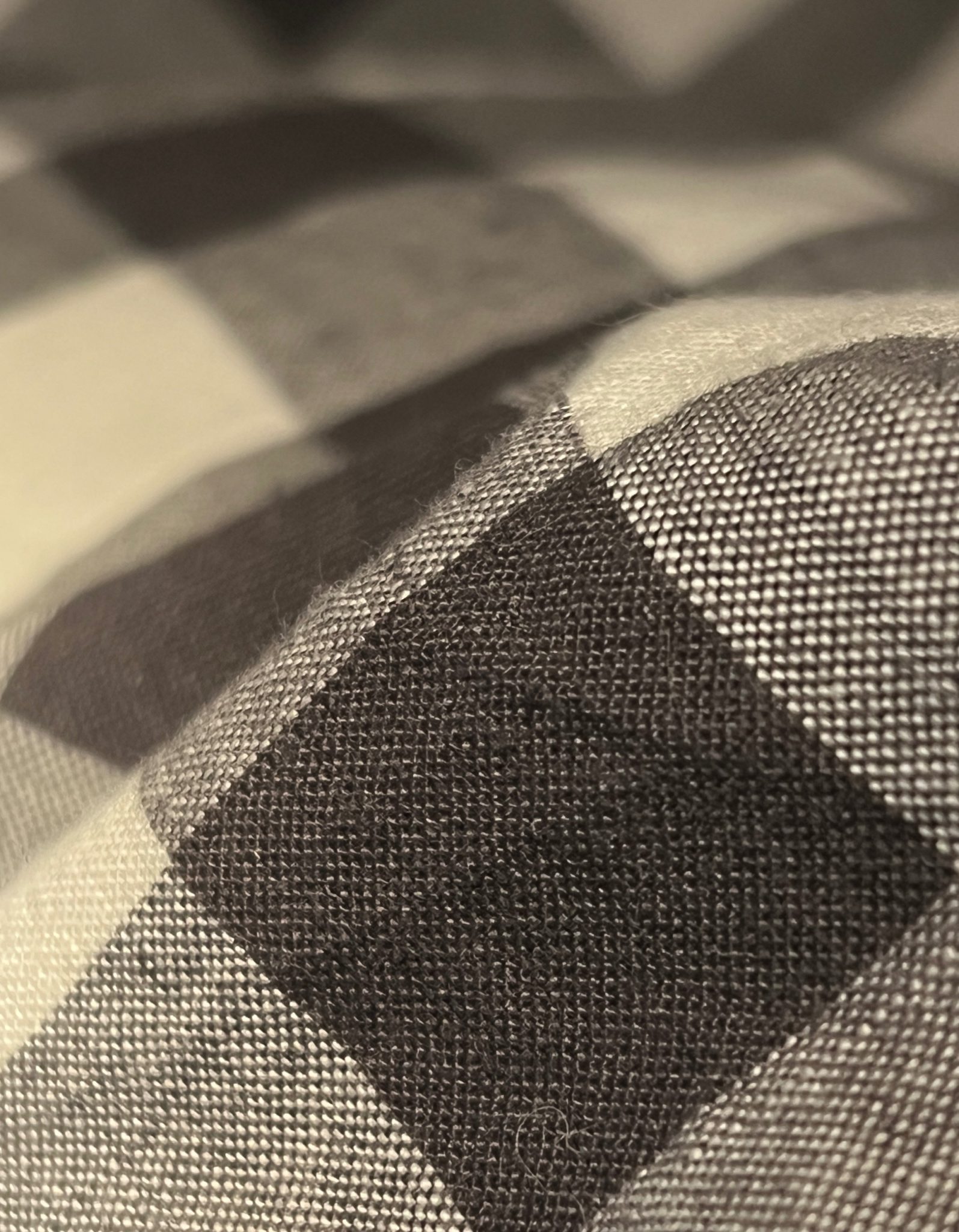 Close up of dark grey and white gingham checked fabric