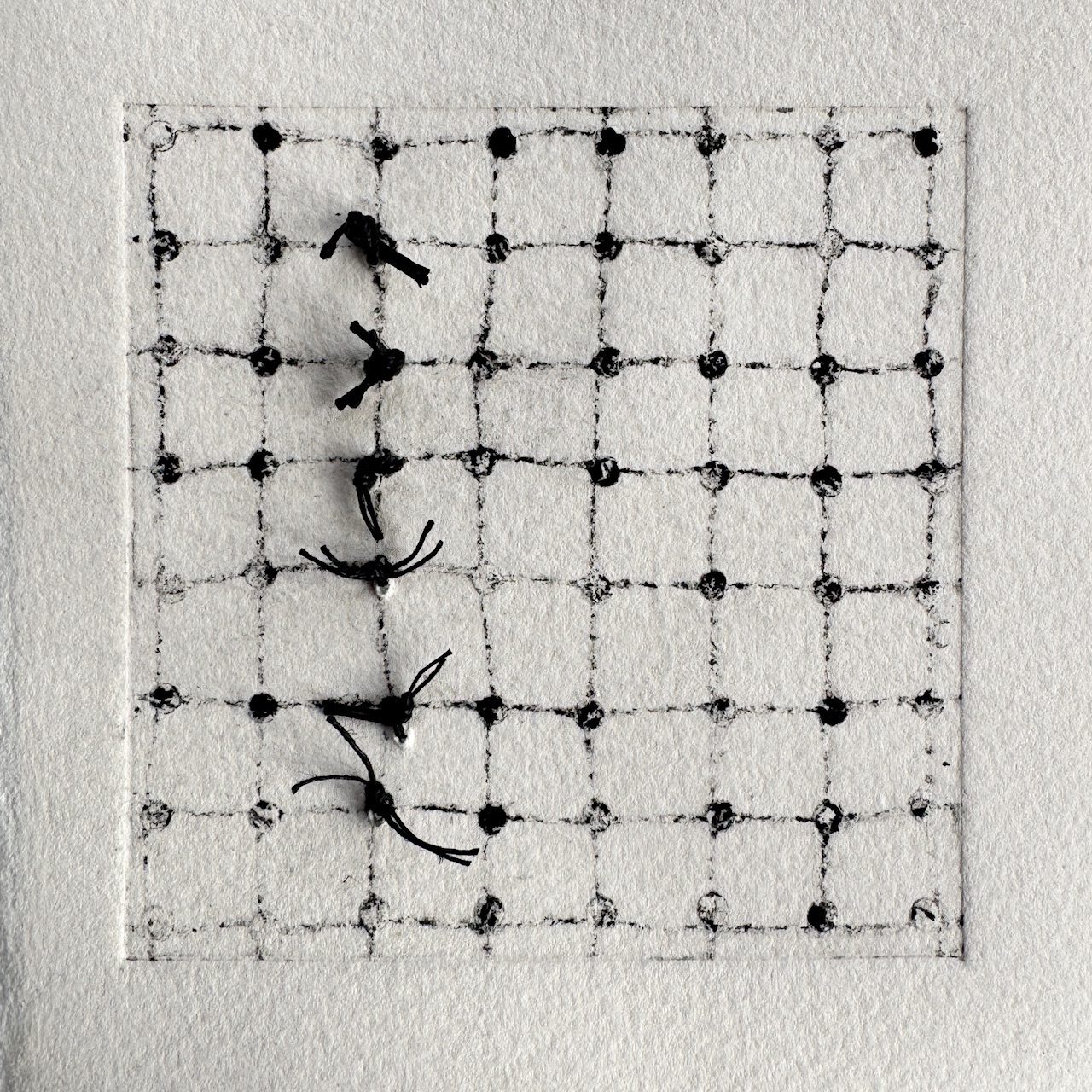 A drypoint print of a grid and dots wit added tufts of stitch in a vertical line