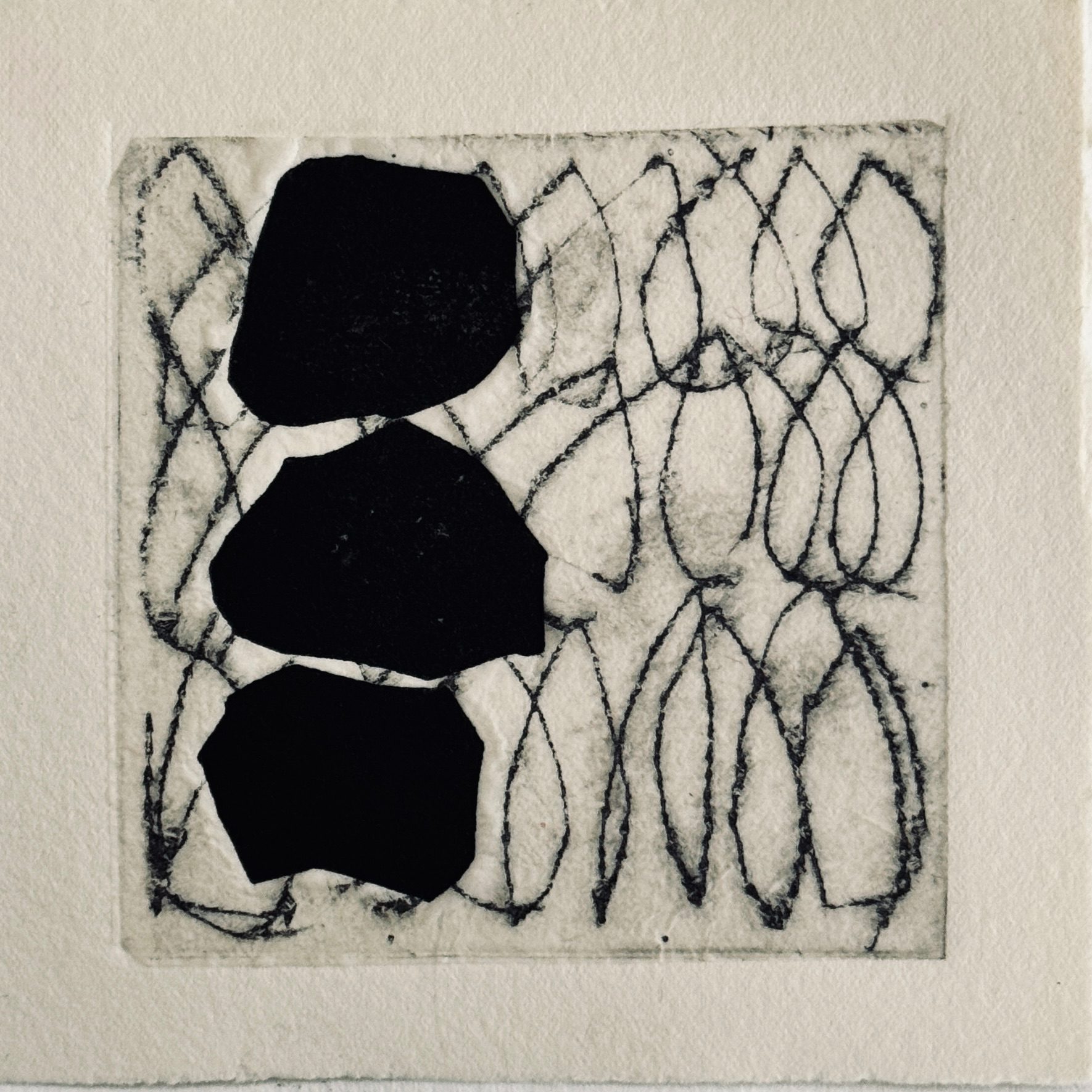 Square relief print with chine collé. The background shows irregular loops with 3 bold black shapes stacked vertically along the left hand side of the print.