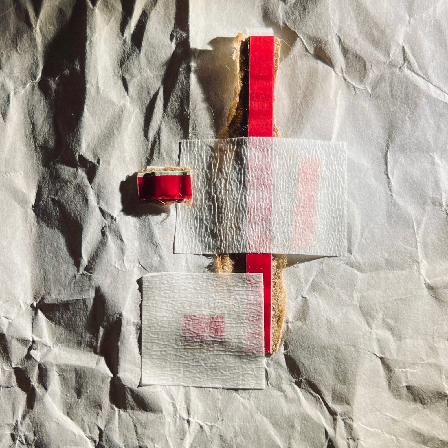 Abstract collage made of rip-strips from cardboard envelopes, masking tape, and crumpled paper.