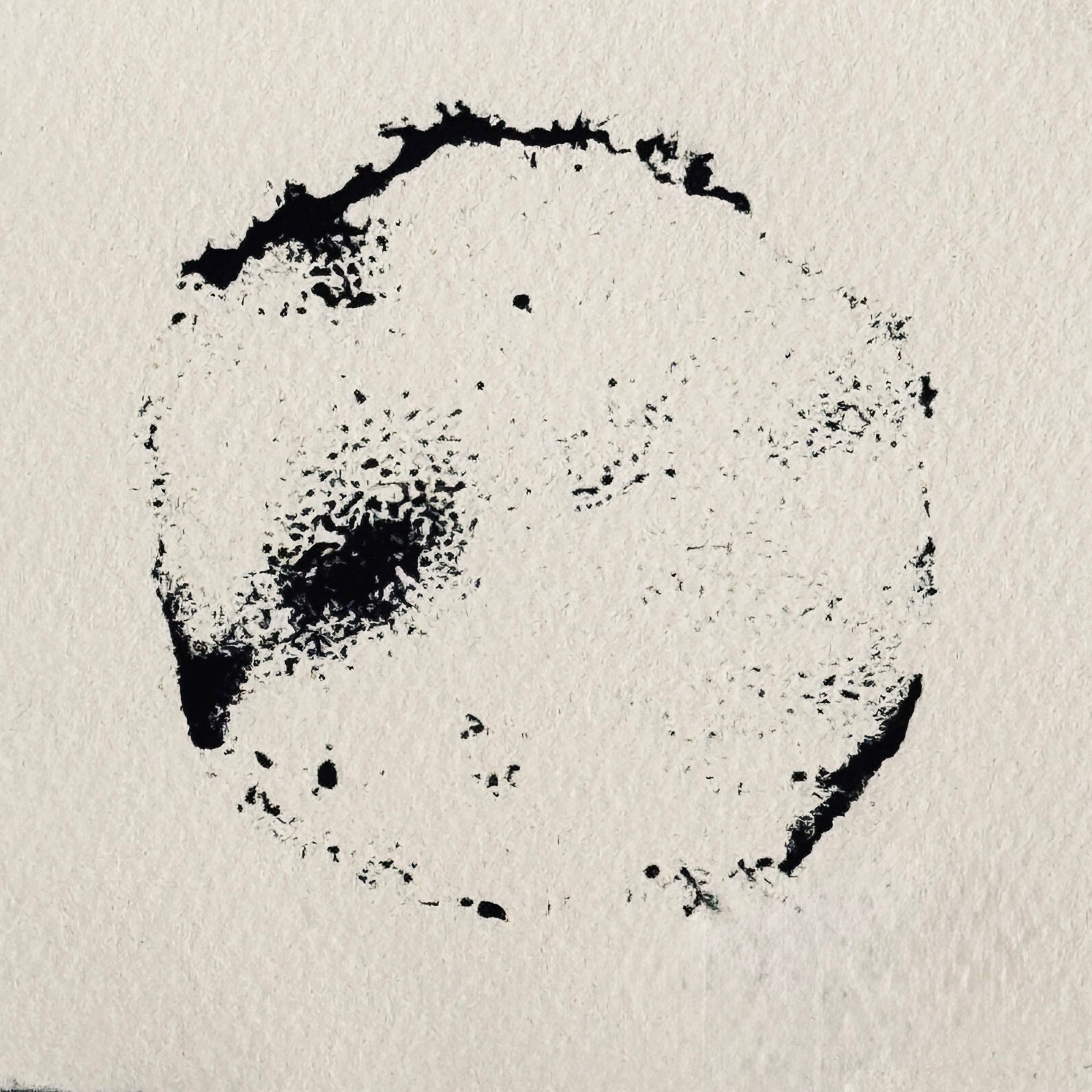 A rough outline of a circular shape printed in black ink.