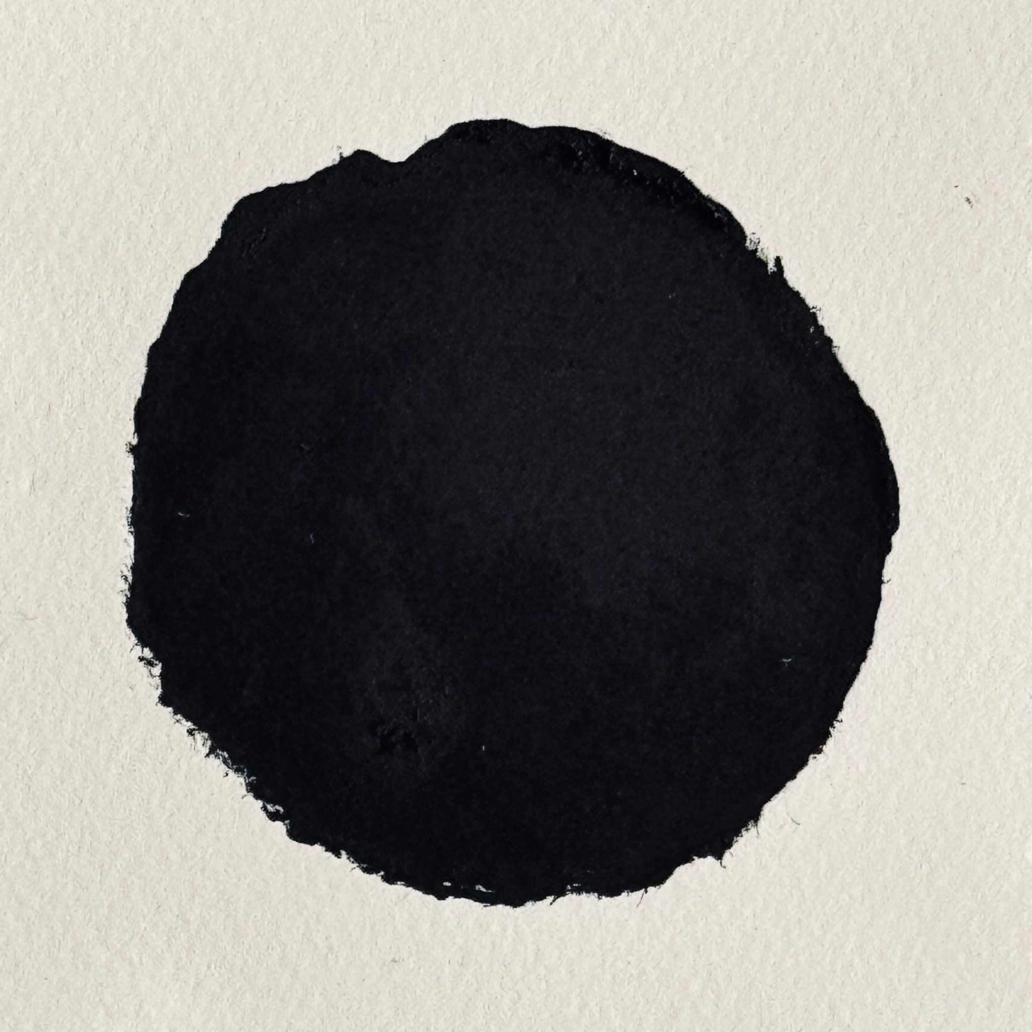 Relief print in black of a circle with torn edges