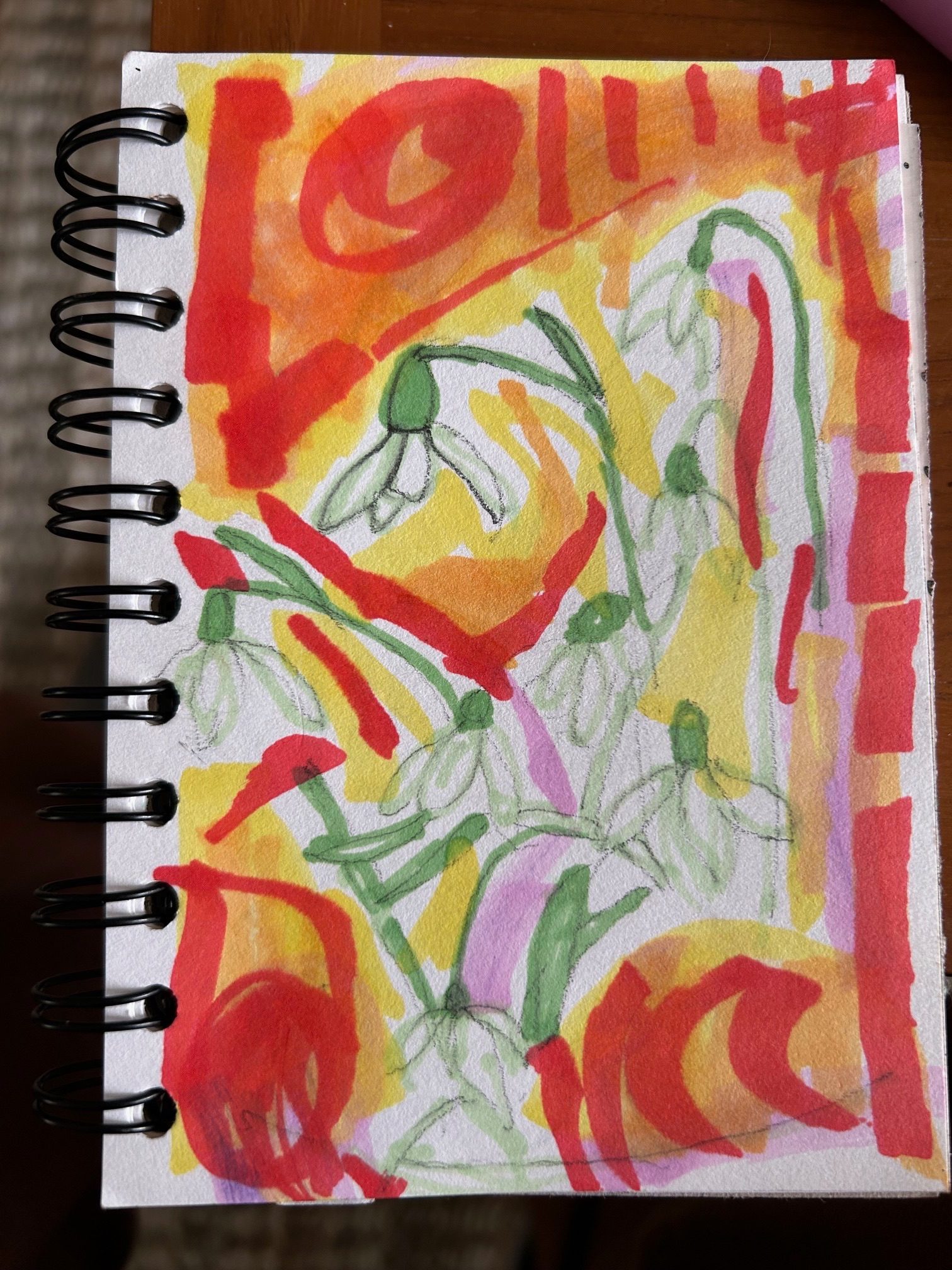 A pencil sketch , by a loved one, of snowdrops has been badly coloured in with markers and a bright coloured background added