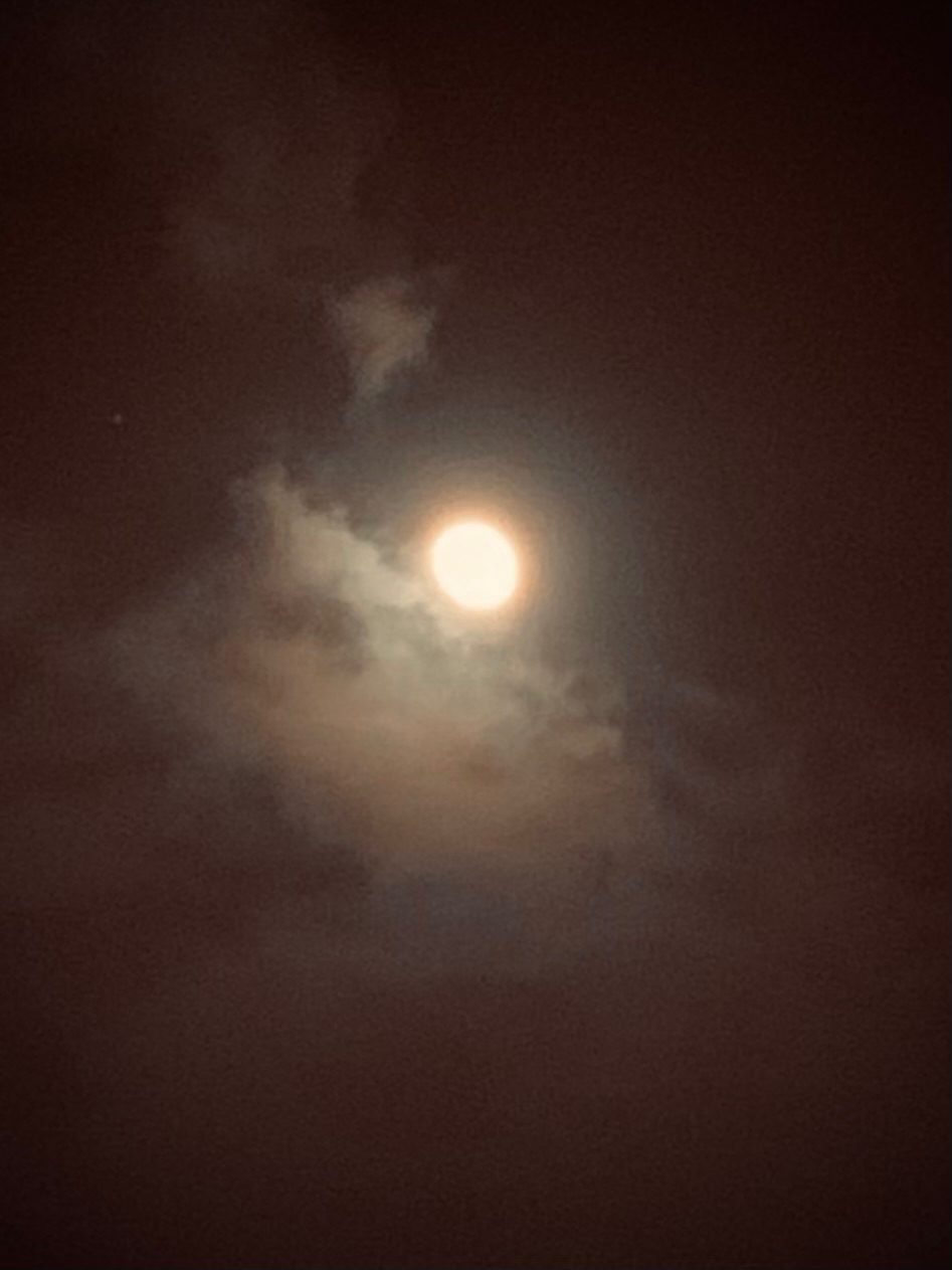 Photograph of the moon on a cloudy sky