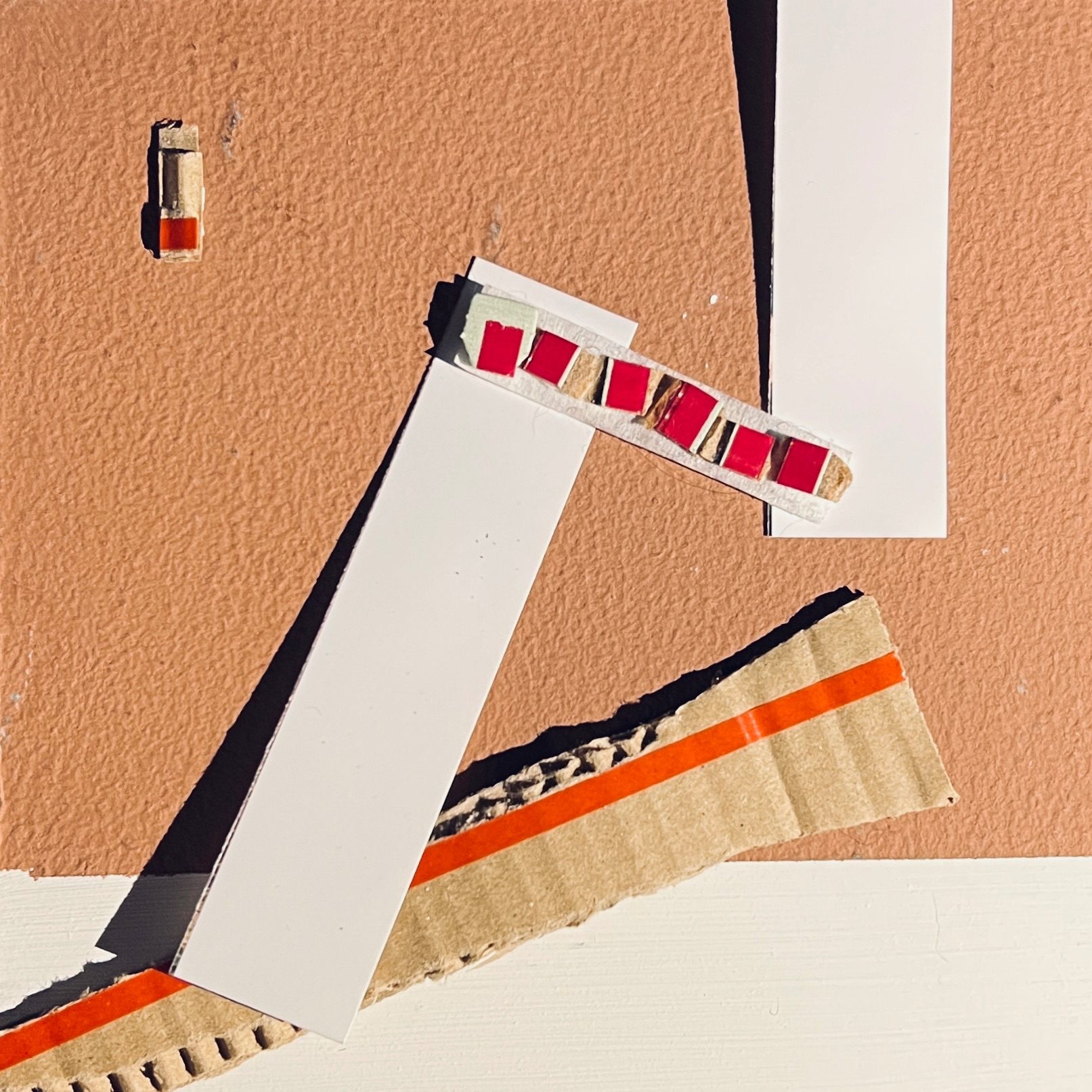 Collage of pieces of rip-strip from cardboard envelopes on a terracotta and cream background.