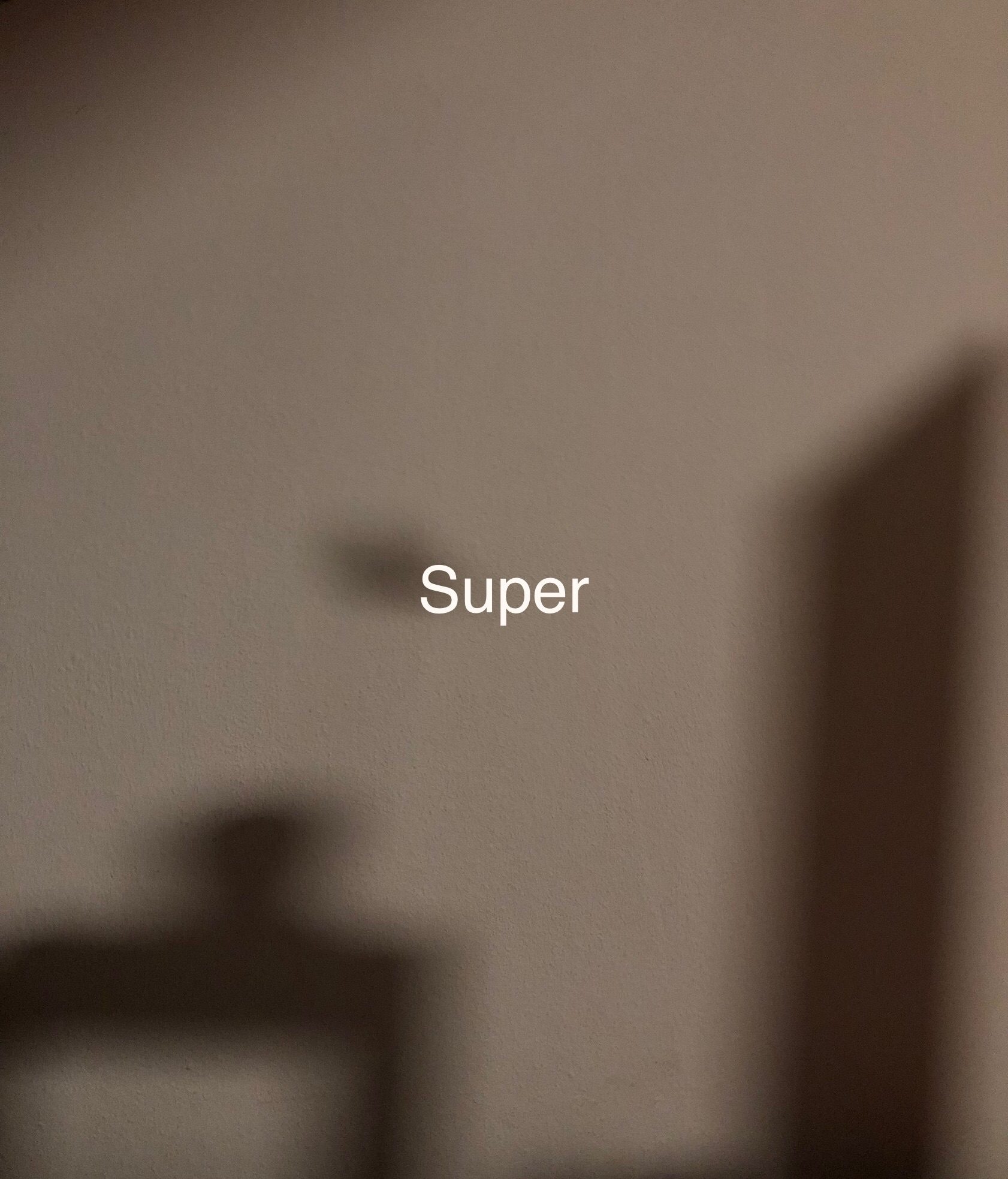 blurry shadows picture with the word super typed in the middle