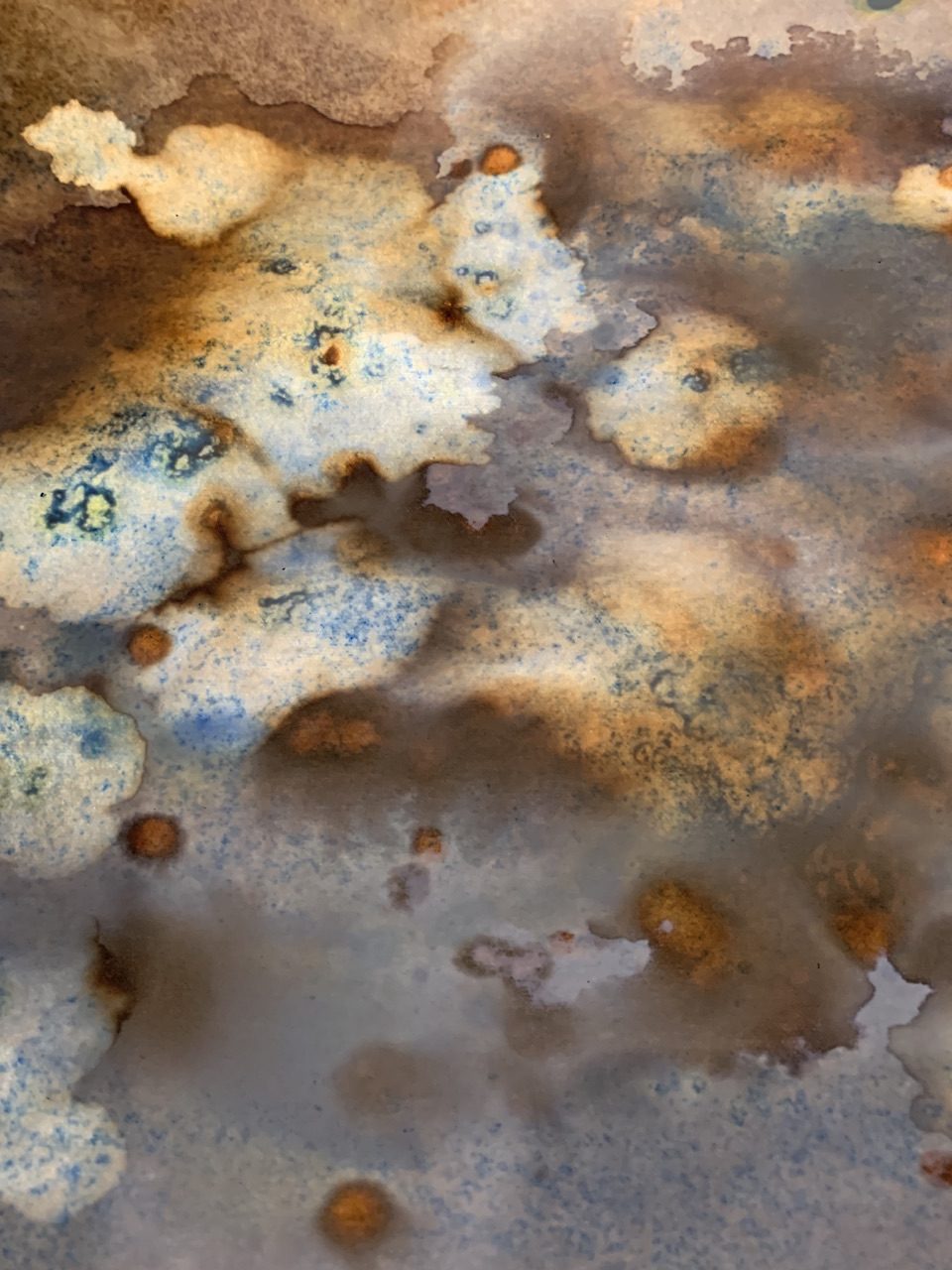 Photograph of the back of a painting ink stains brown blue