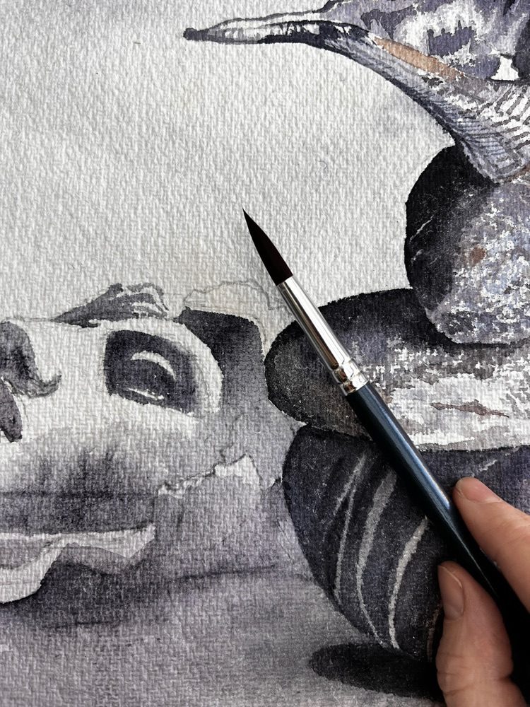 Surreal watercolour work in progress, medusa head and stack of stones in a landscape