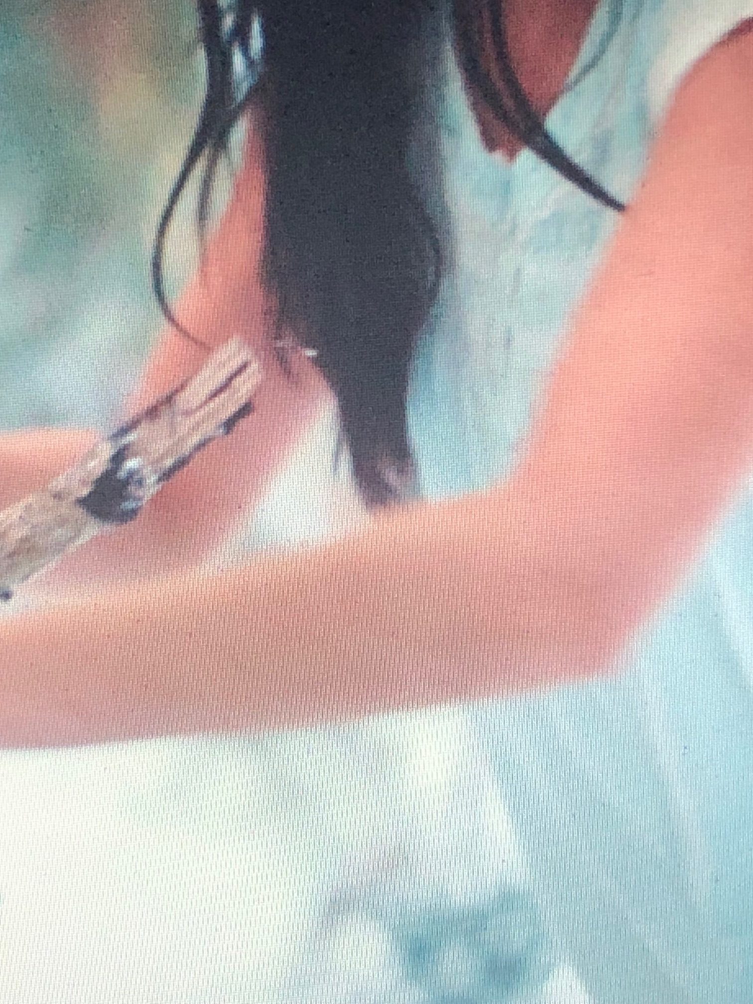 screenshot of close-up arms and hair