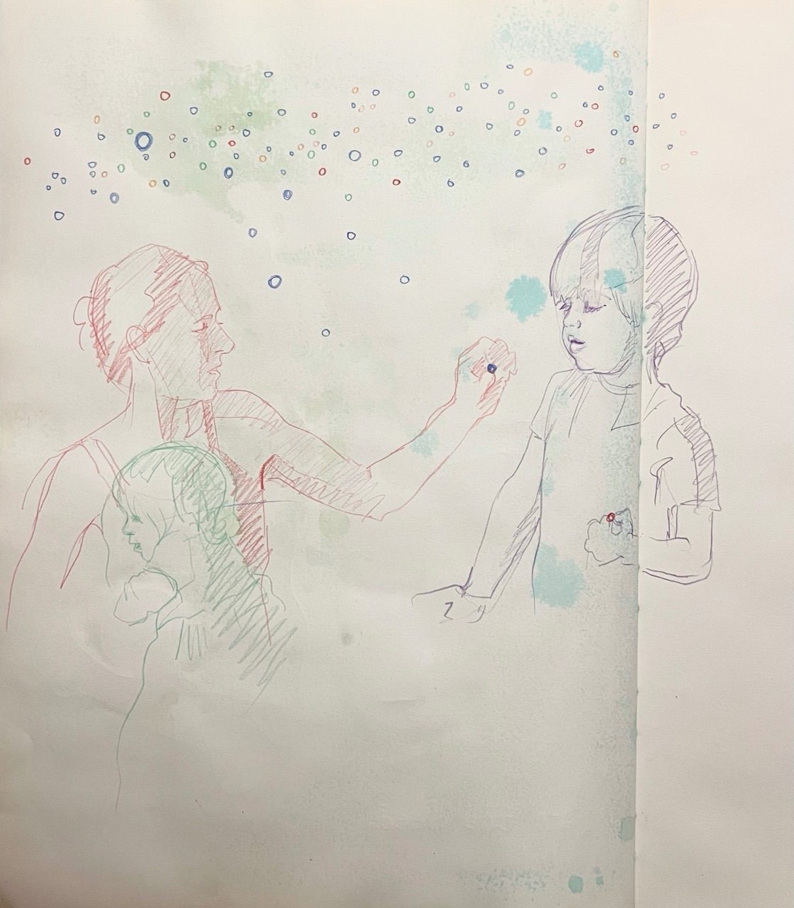 Woman hold out a tiny ball to a boy who is holding a tiny ball of a different colour