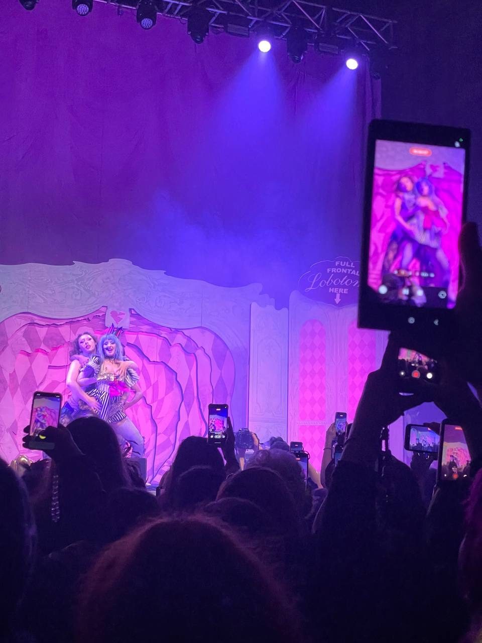 Photo of people’s phones at a gig