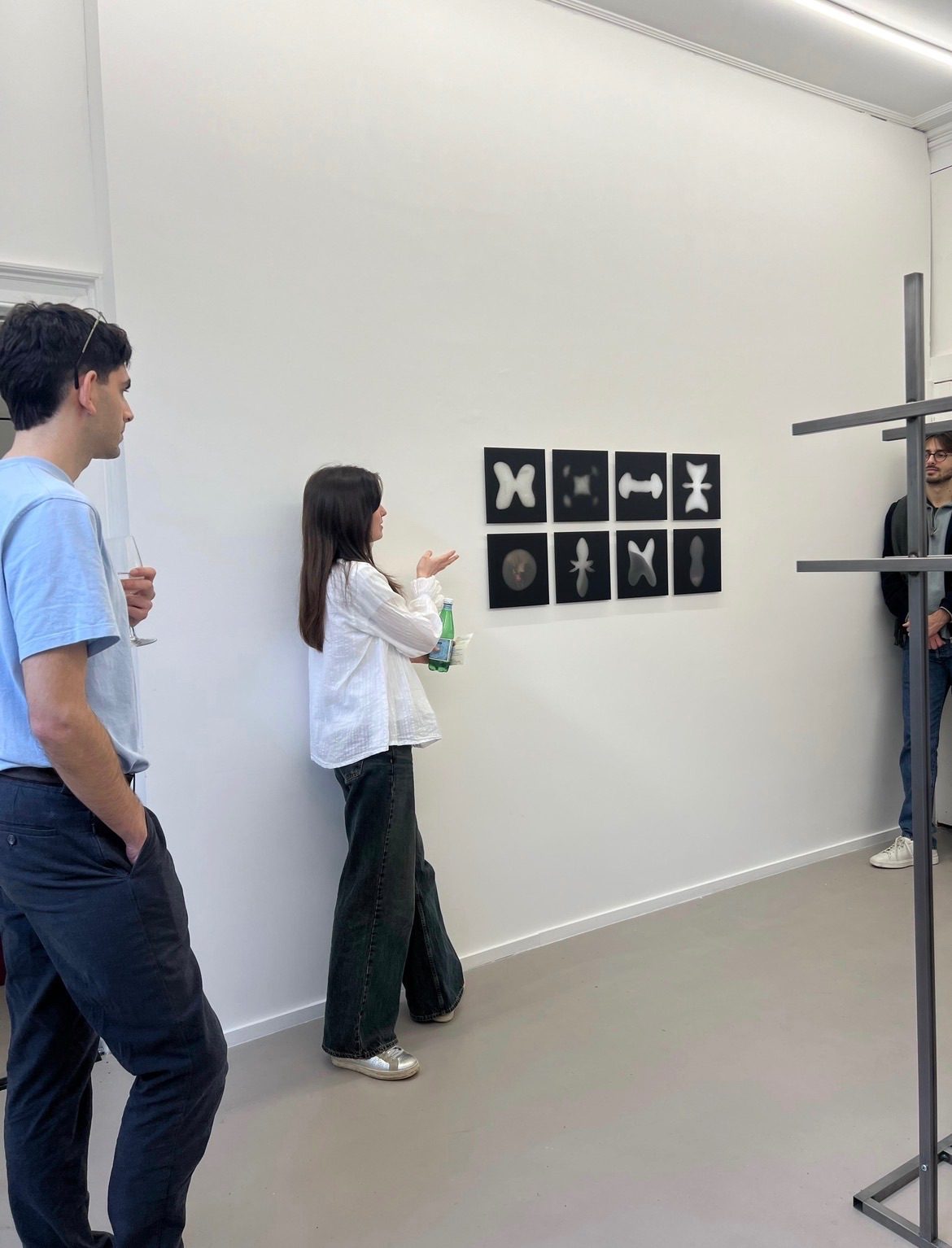 People talking in front of spray painted mirror artwork