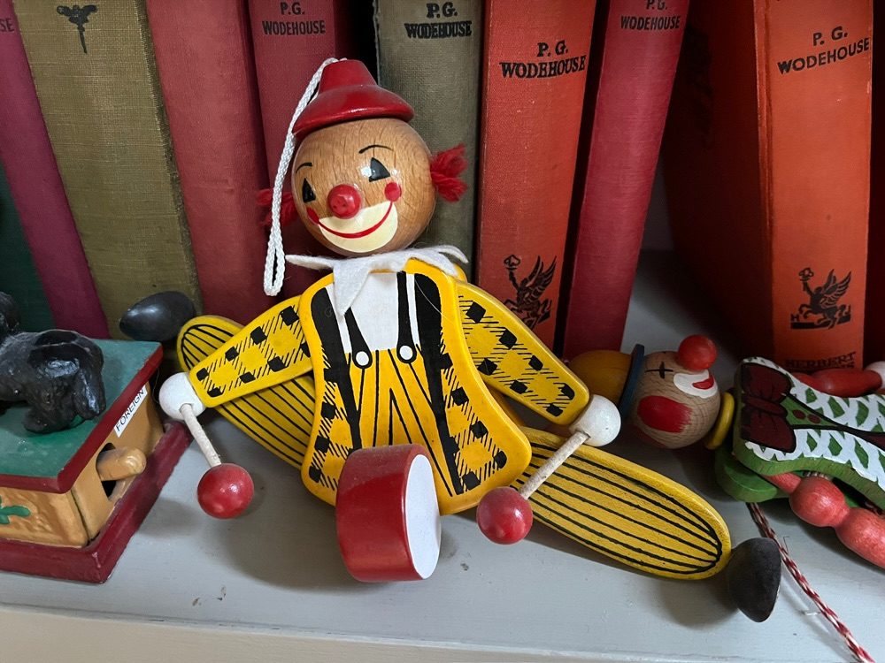 Wooden colourful toy clown collapsed on the shelf