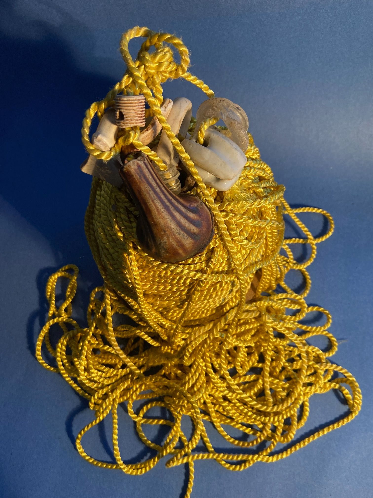 a vew from above of the golden chord mountain showing a bundle of threaded ceramic and glass objects