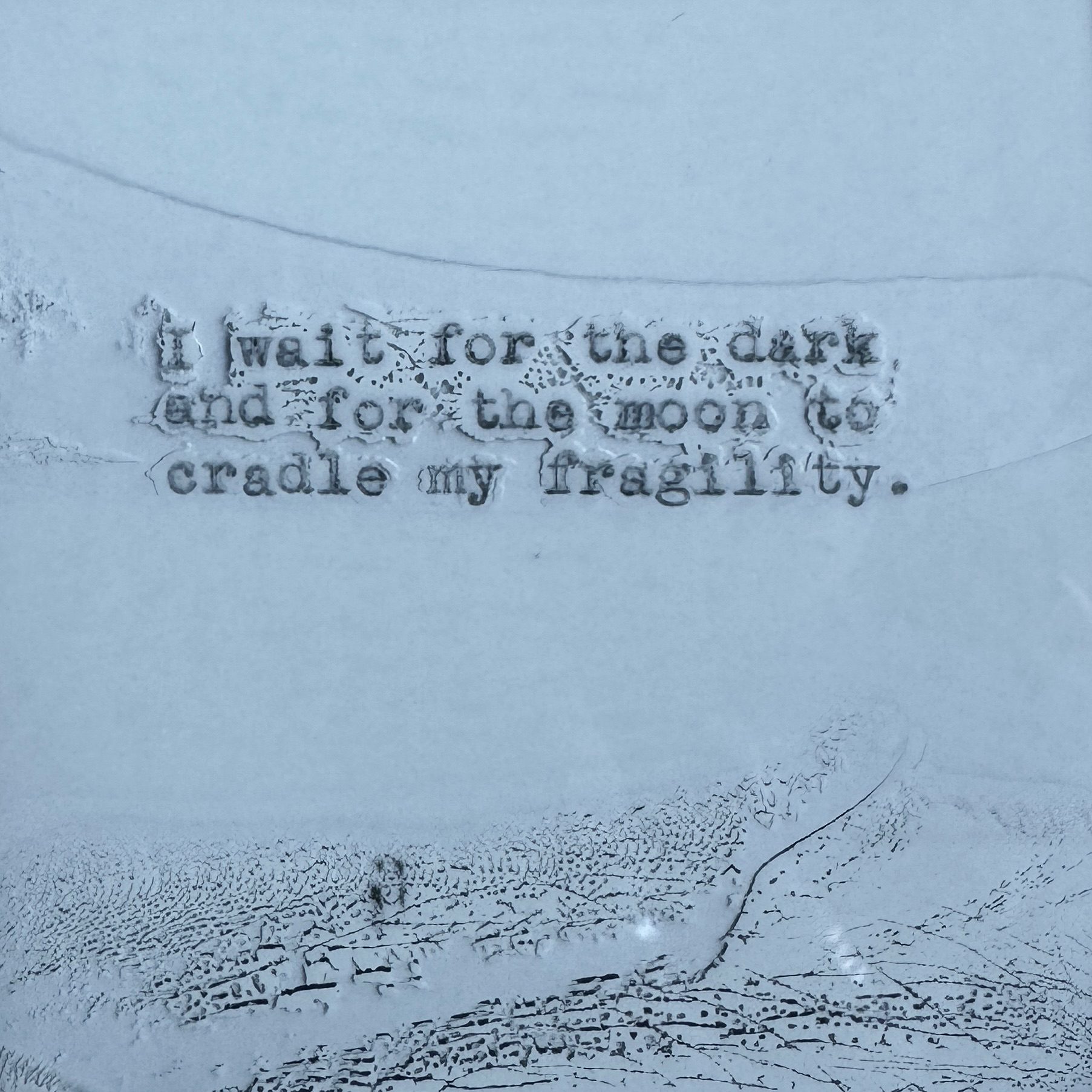 A black and white abstract Polaroid photo with text typed onto it with a manual typewriter