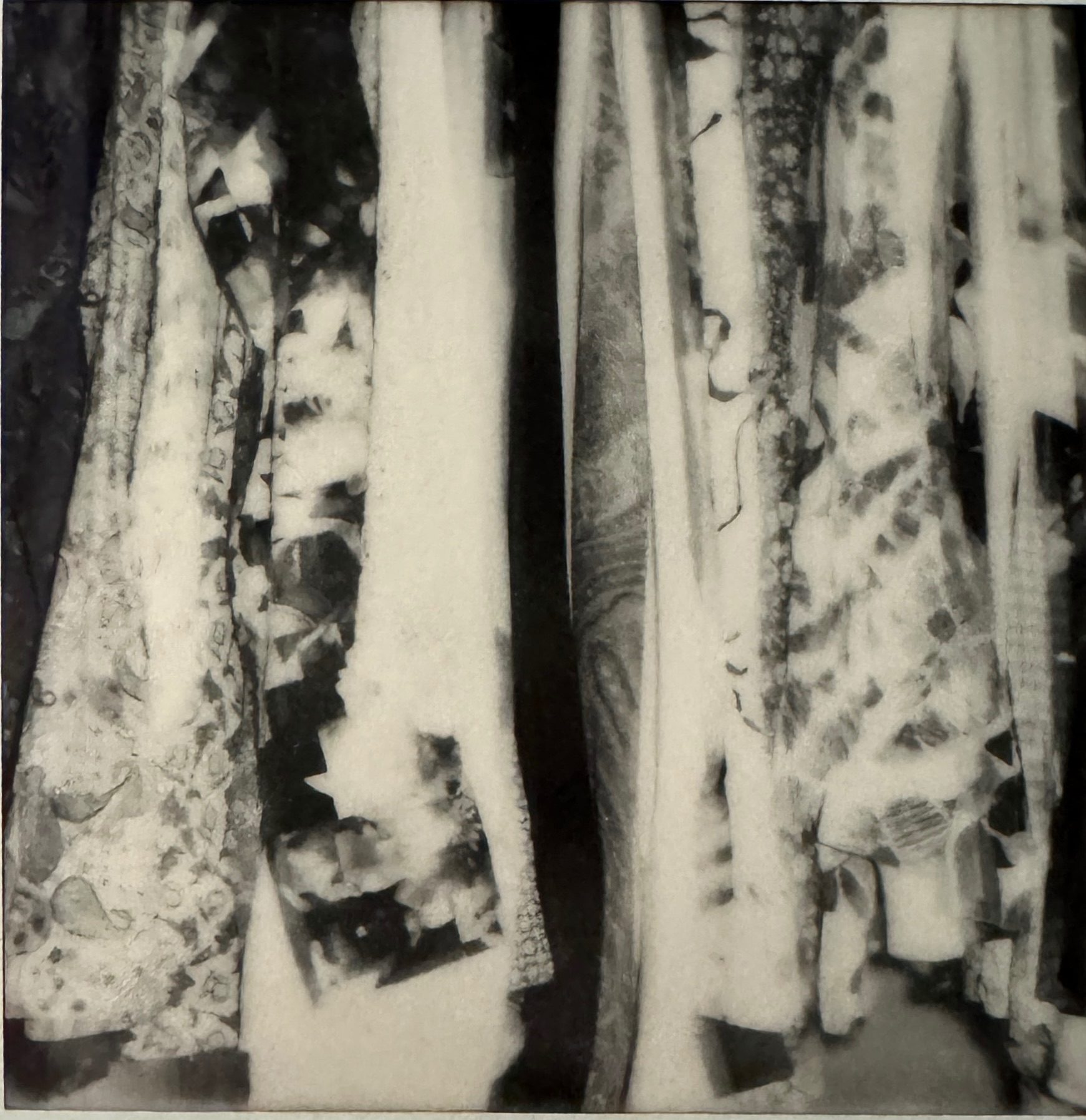 A black and white abstract Polaroid  photo showing what looks like folds of fabric