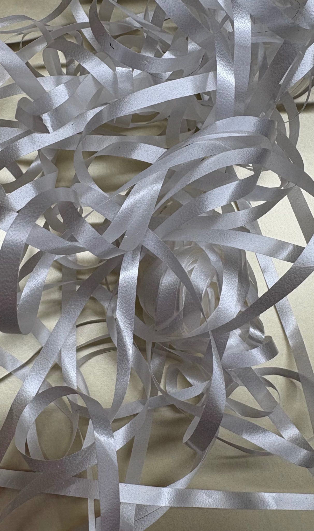 White wrapping tape in a messy knot on a gold paper