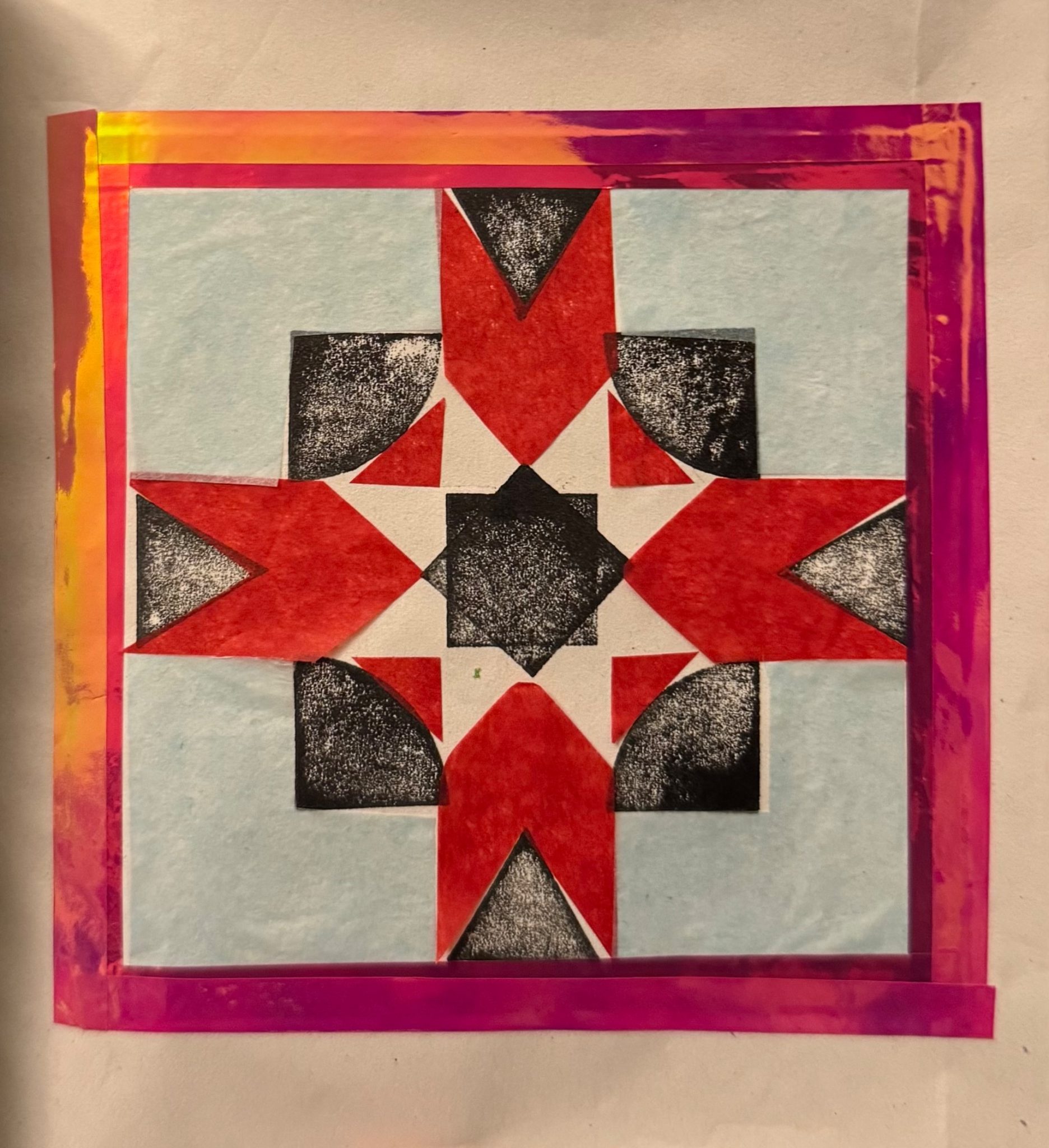 Black and white shapes to form a pattern with coloured tissue paper. Surrounded by a square shiny tape frame.