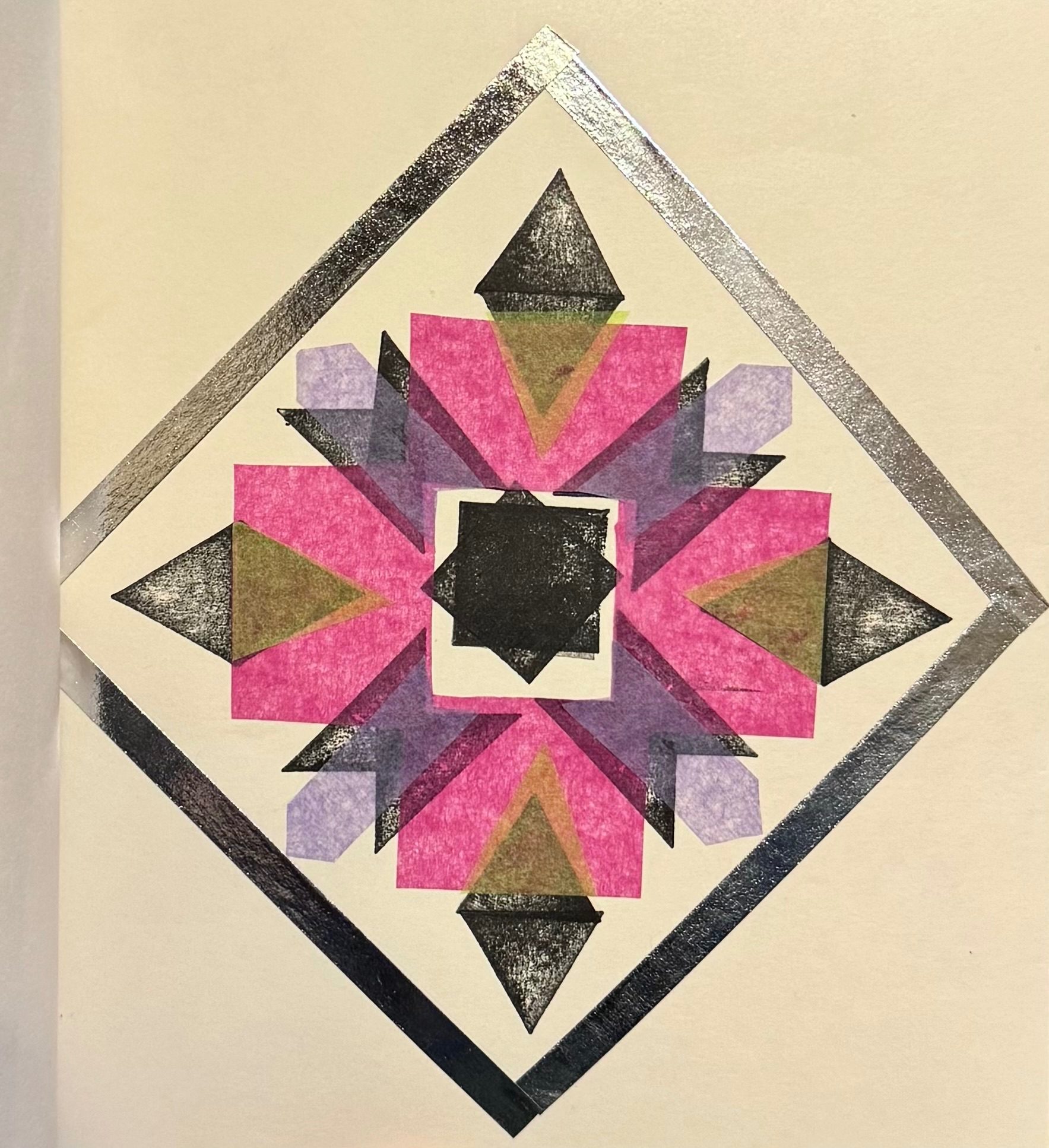 Black and white shapes with tissue paper colours in a diamond shape with silver tape.