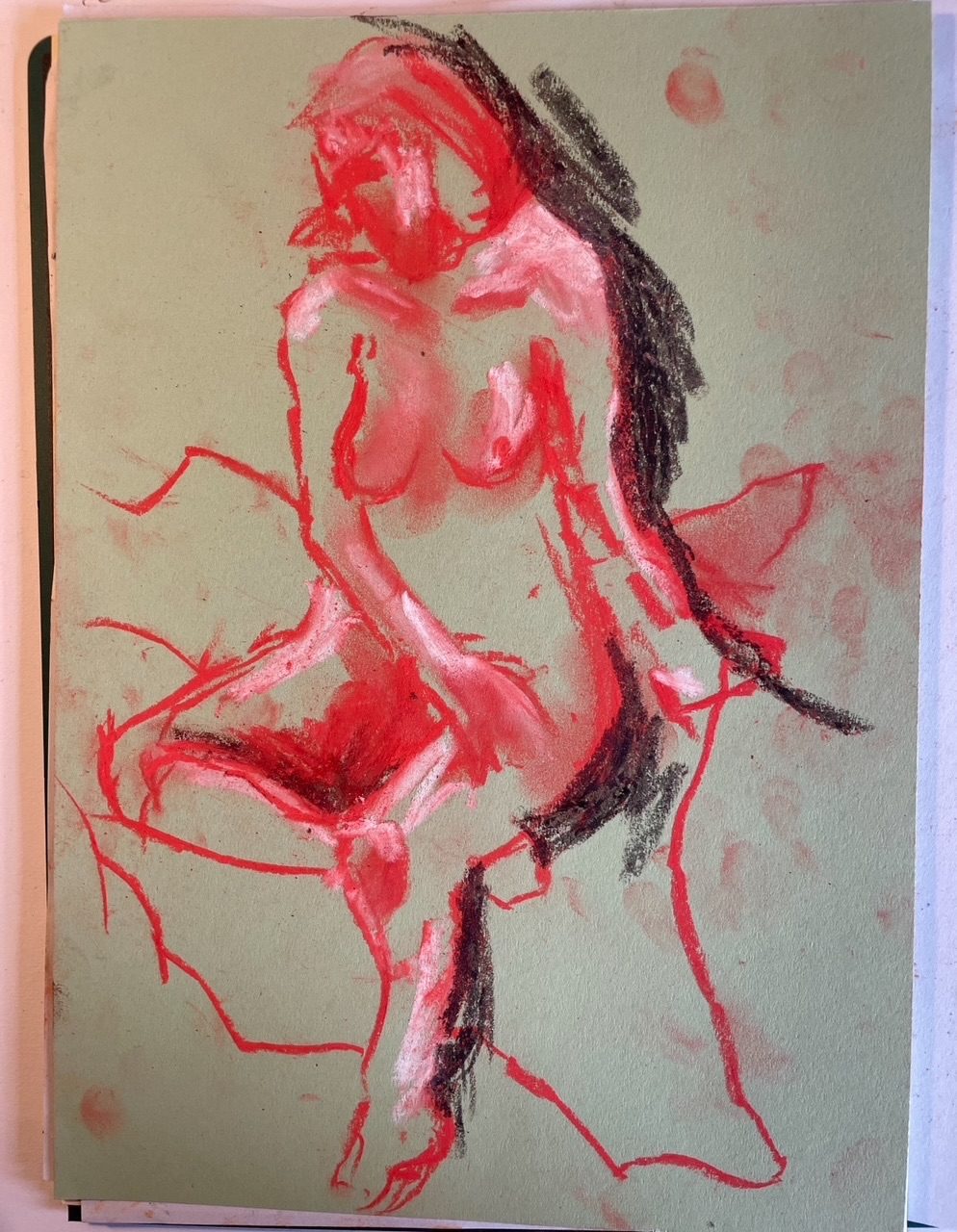A pastel drawing in pink and red of a nude woman, quickly done.