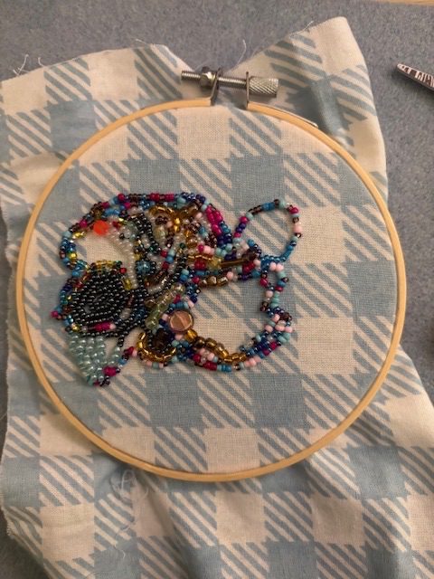 beaded embroidery on blue plaid fabric