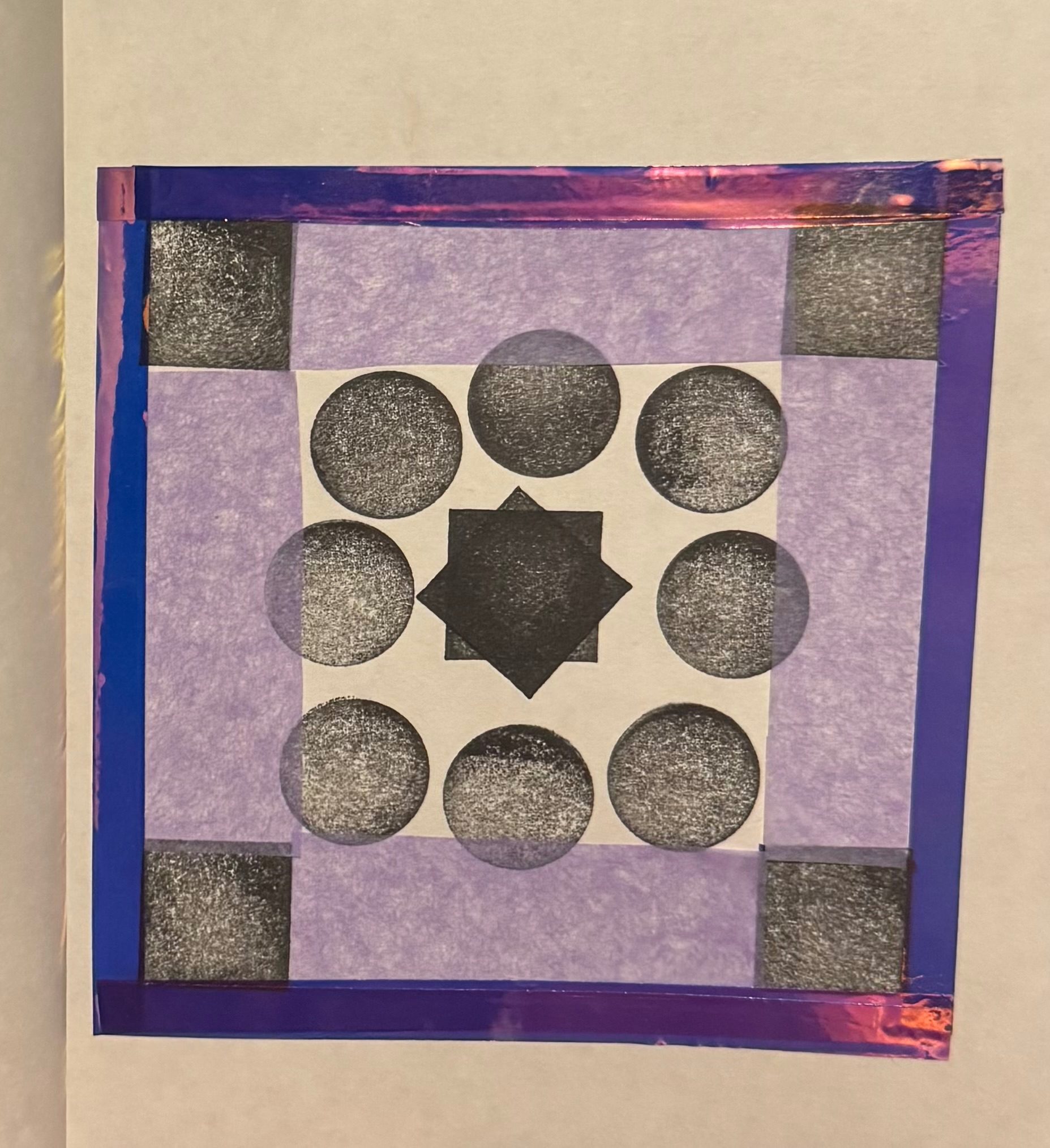 Black and white patterns with coloured tissue paper and a tape border.