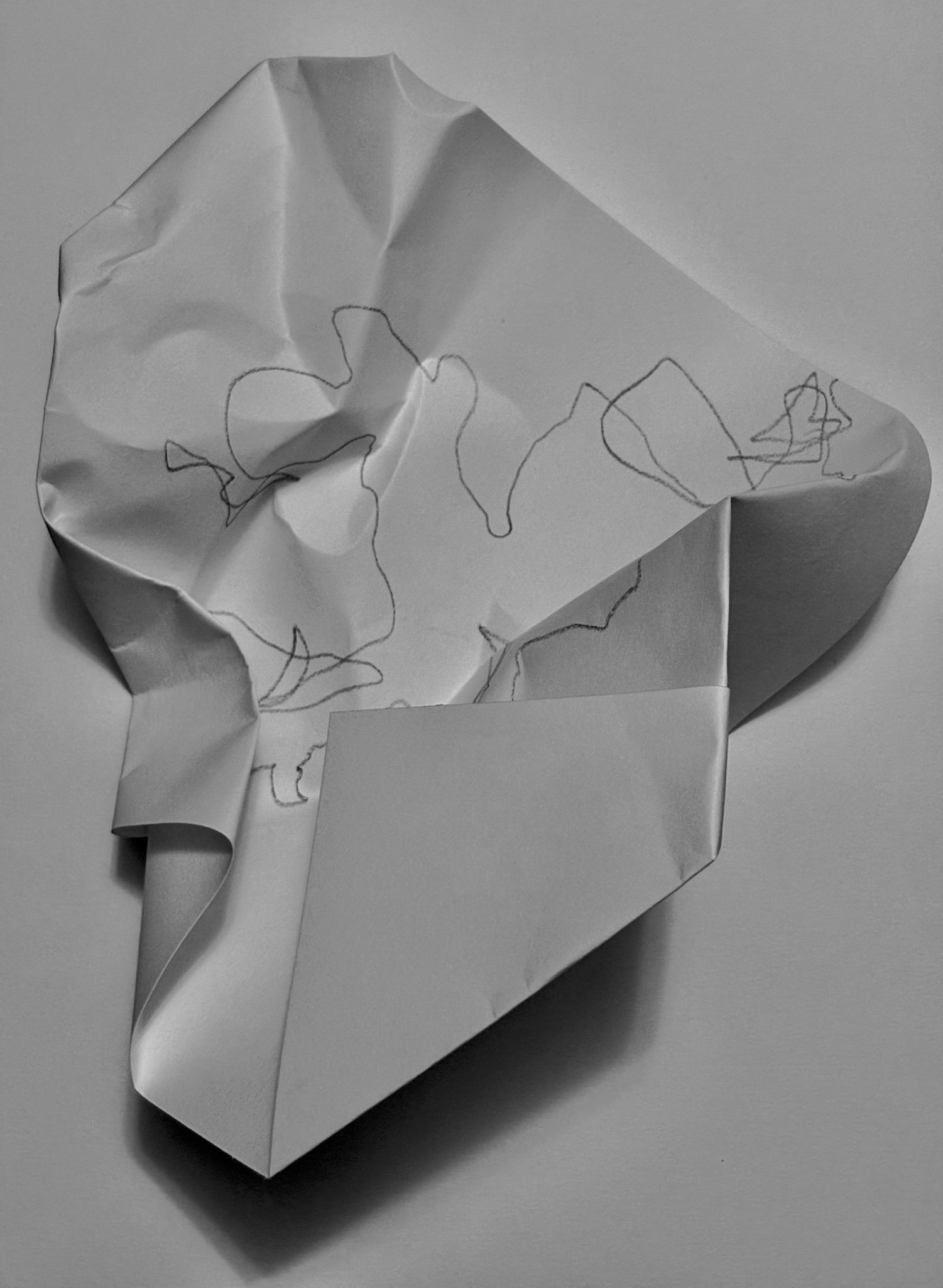 On paper, eyes closed, drawing a folder paper via touch. Then folding the paper with the drawing.  The blindfolded fold, within a folding.