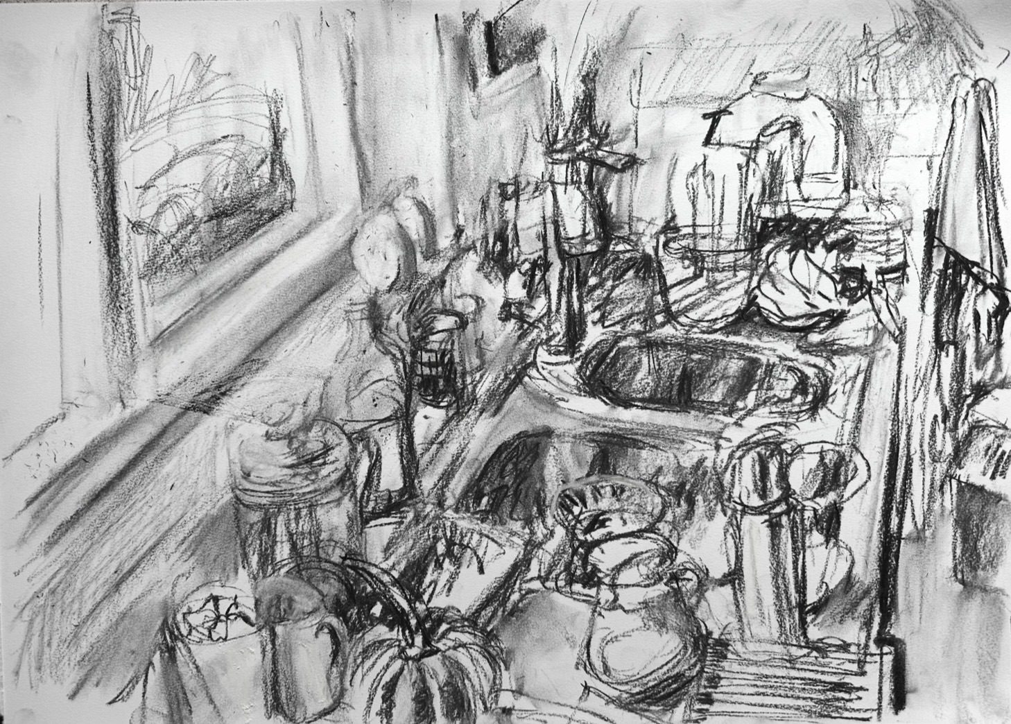 Charcoal drawing on paper. View of untidy kitchen looking along worktop.