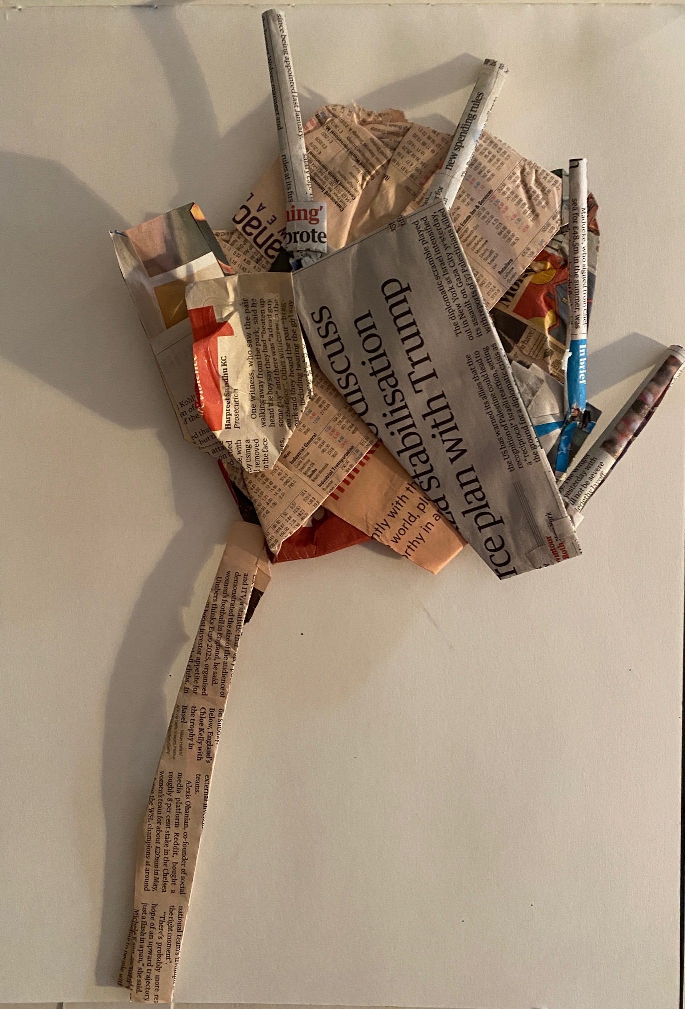 Flattened newspaper forms reassembled