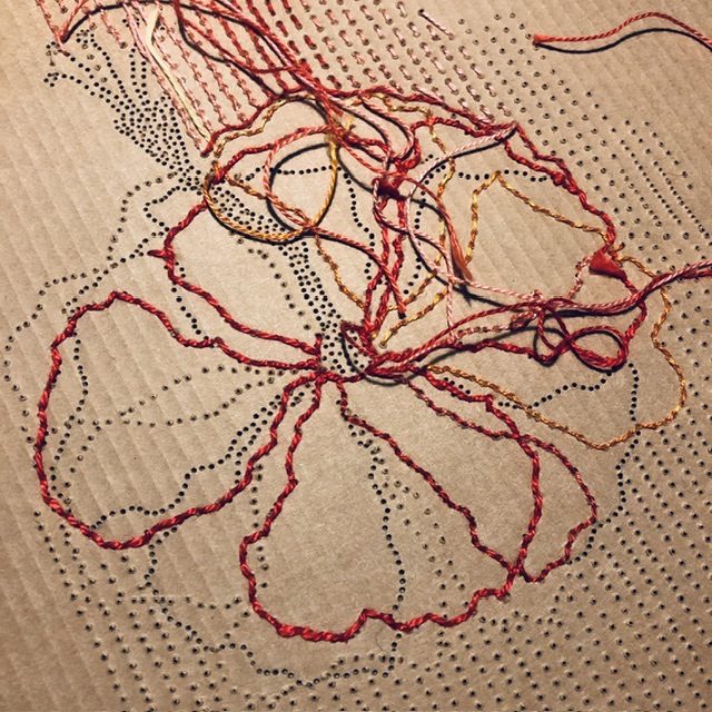 Embroidery in red camaïeu on corrugated cardboard, it's one or more hibiscus