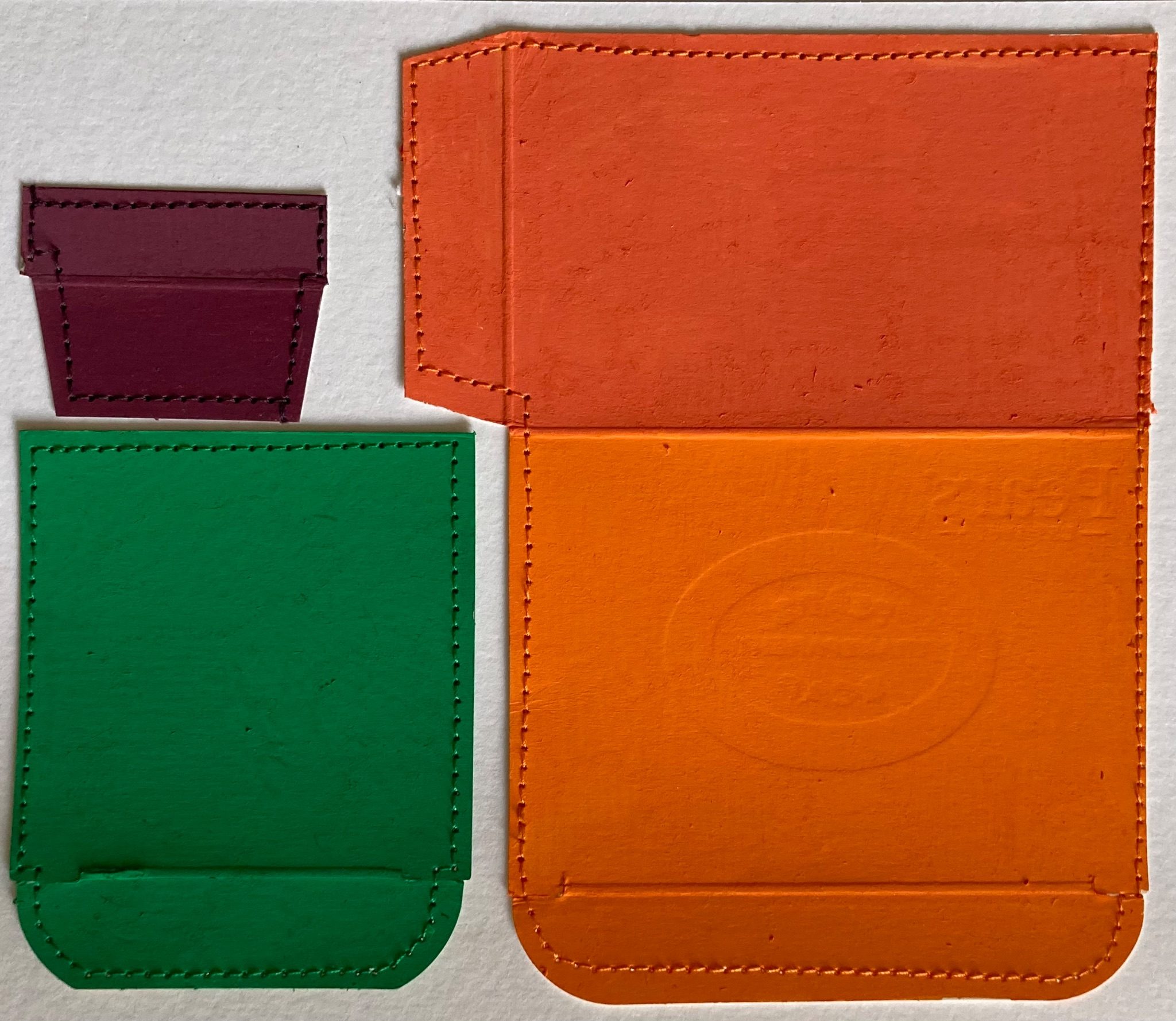 Coloured cardboard box packaging, sewn onto card