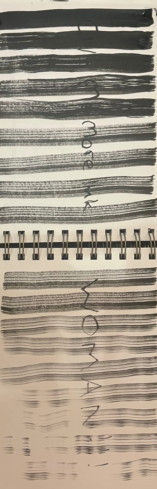 Strikes of ink that slowly start to lose their pigment with the words “give me more ink woman” written over the top