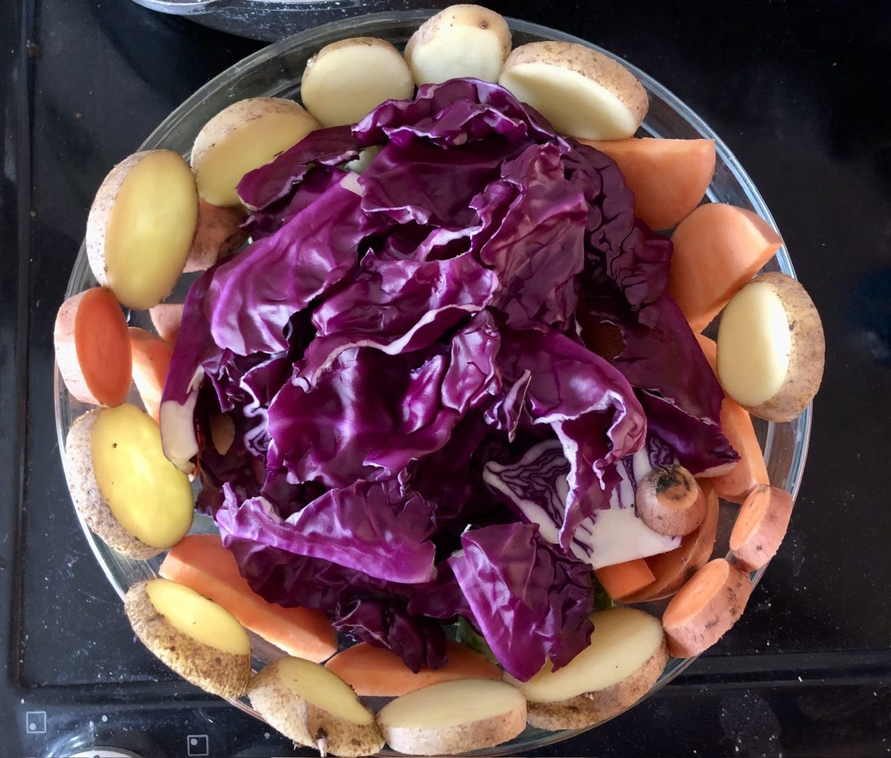 Colourful red cabbage sweet potato carrots and sprouts in Bowl