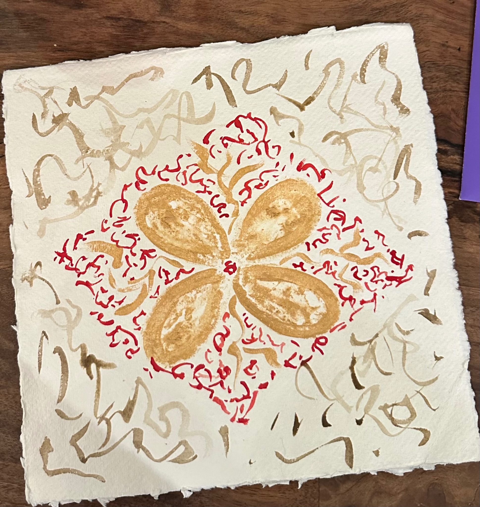 Scribbling in shape of a flower withbgold ink and watercolours