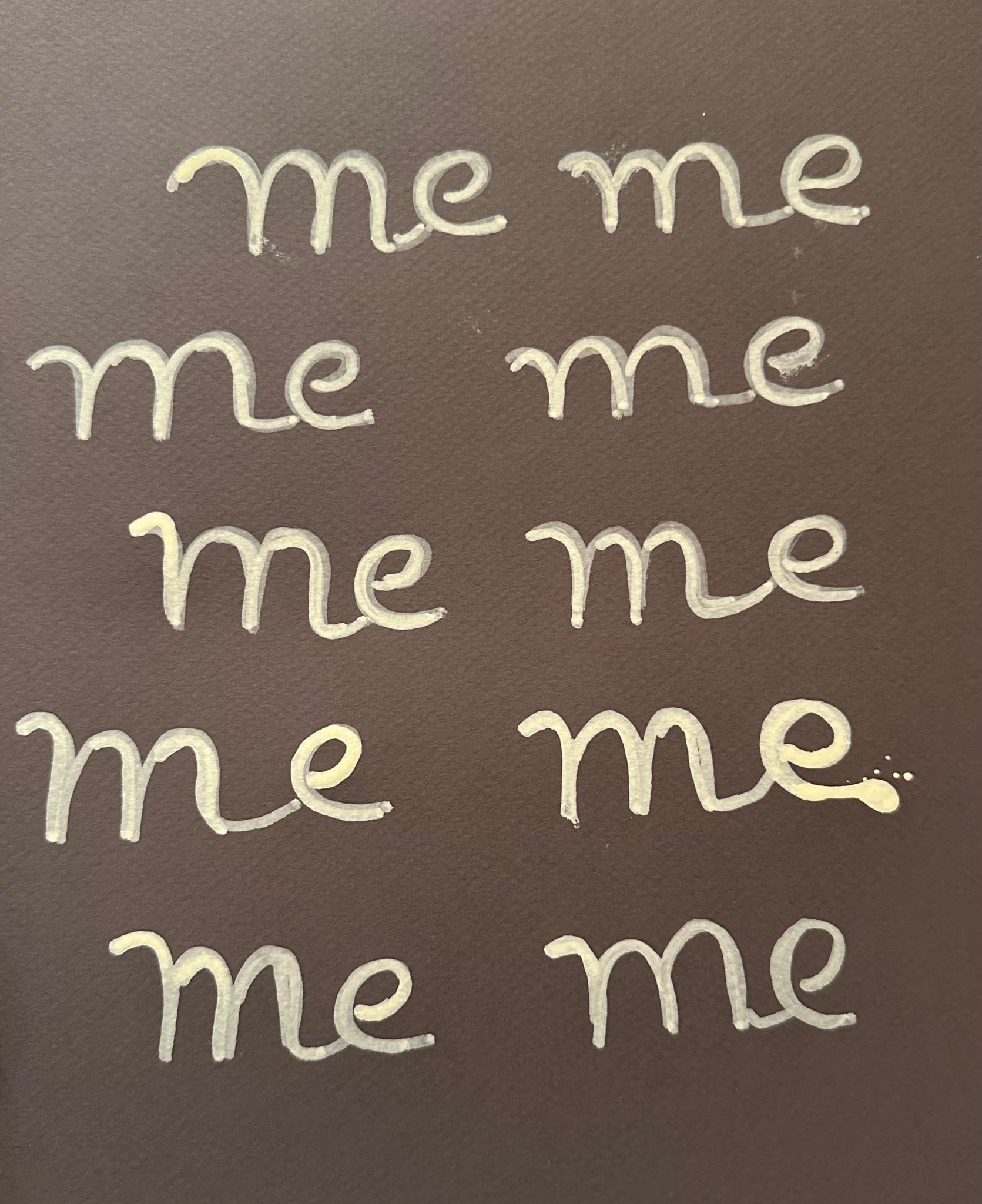 Repetitive writing of the word ME in cream on a brown background